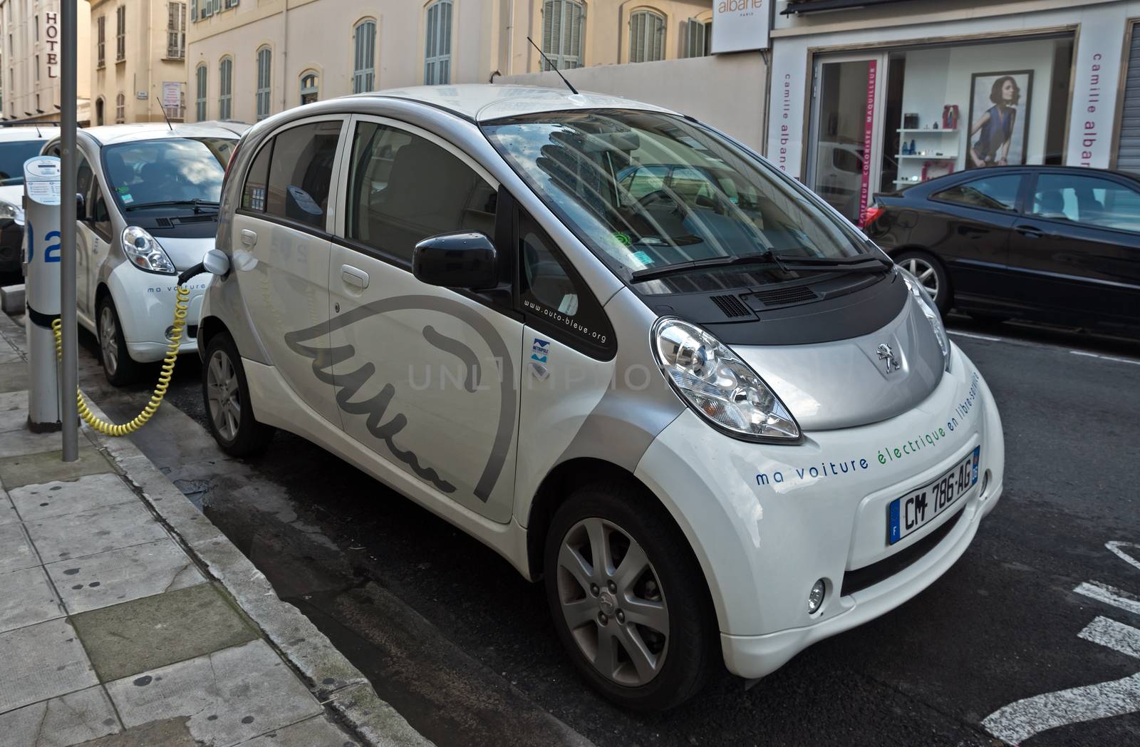 NICE, FRANCE - JUNE 2, 2014: Electric cars charging on a street in the city of Nice.

Nice, France - June 2, 2014: Electric cars charging on a street in the city of Nice.