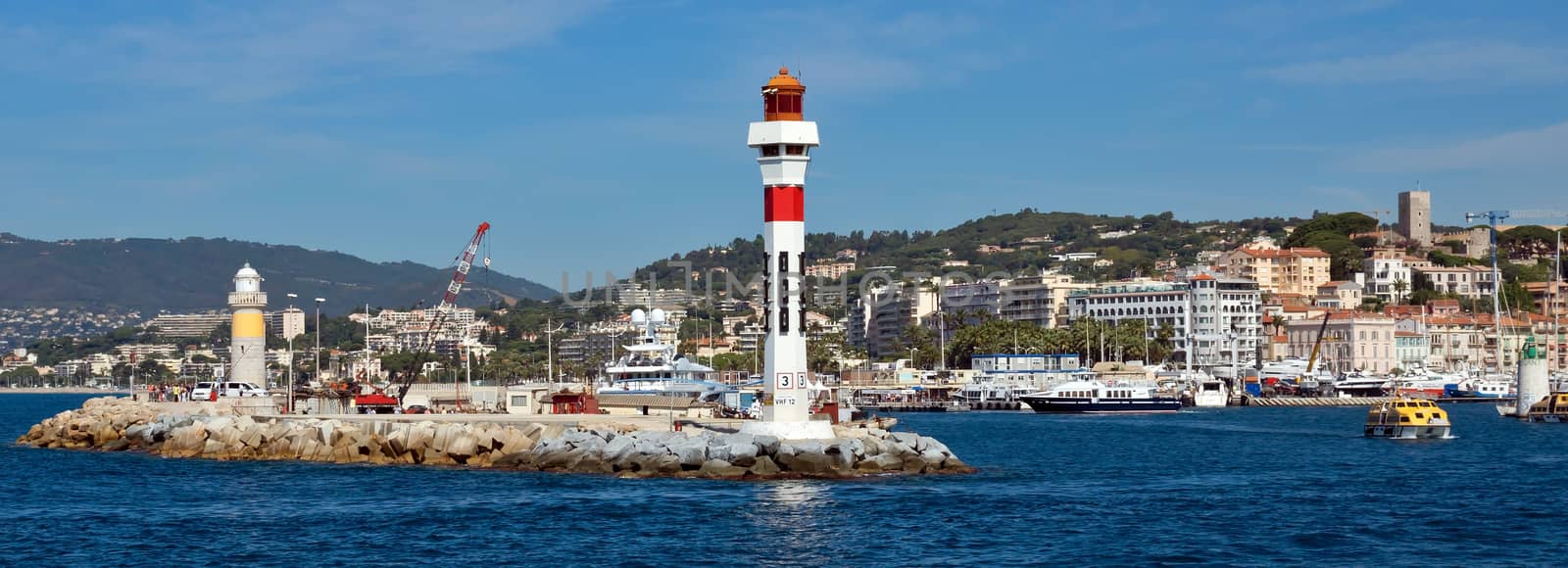 CANNES, FRANCE - JUNE 5, 2014: Lighthouse tower at port entrance in city of Cannes, France. Port de Cannes was started in 1745.

Cannes, France - June 5, 2014: Lighthouse tower at port entrance in city of Cannes, France. Port de Cannes was started in 1745.
