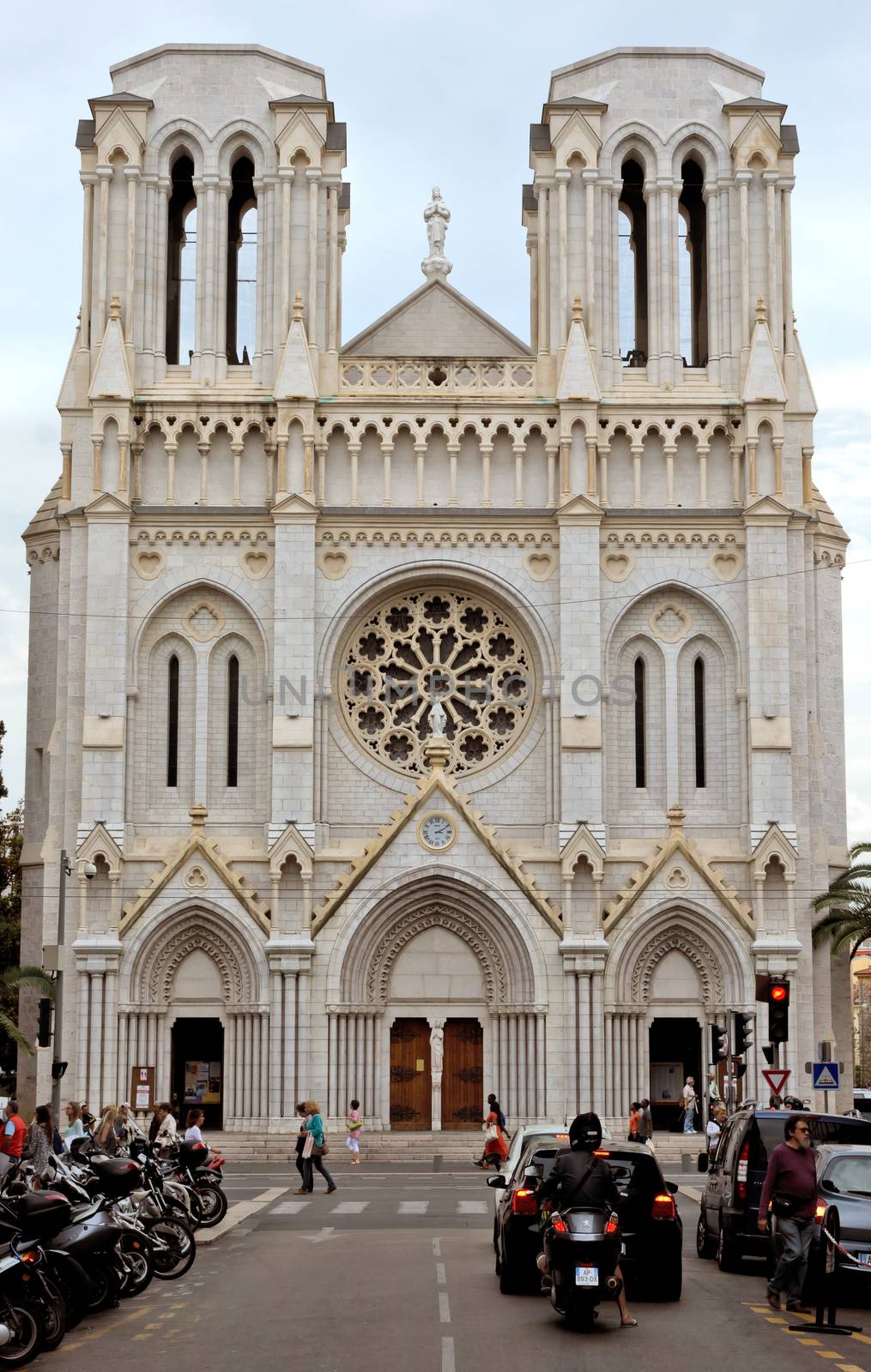 NICE, FRANCE - JUNE 4, 2014: Basilique Notre Dame. It was built in the years 1864-1868 in neo-Gothic style.

Nice, France - June 4, 2014: Basilique Notre Dame. It was built in the years 1864-1868 in neo-Gothic style. People are walking by street.