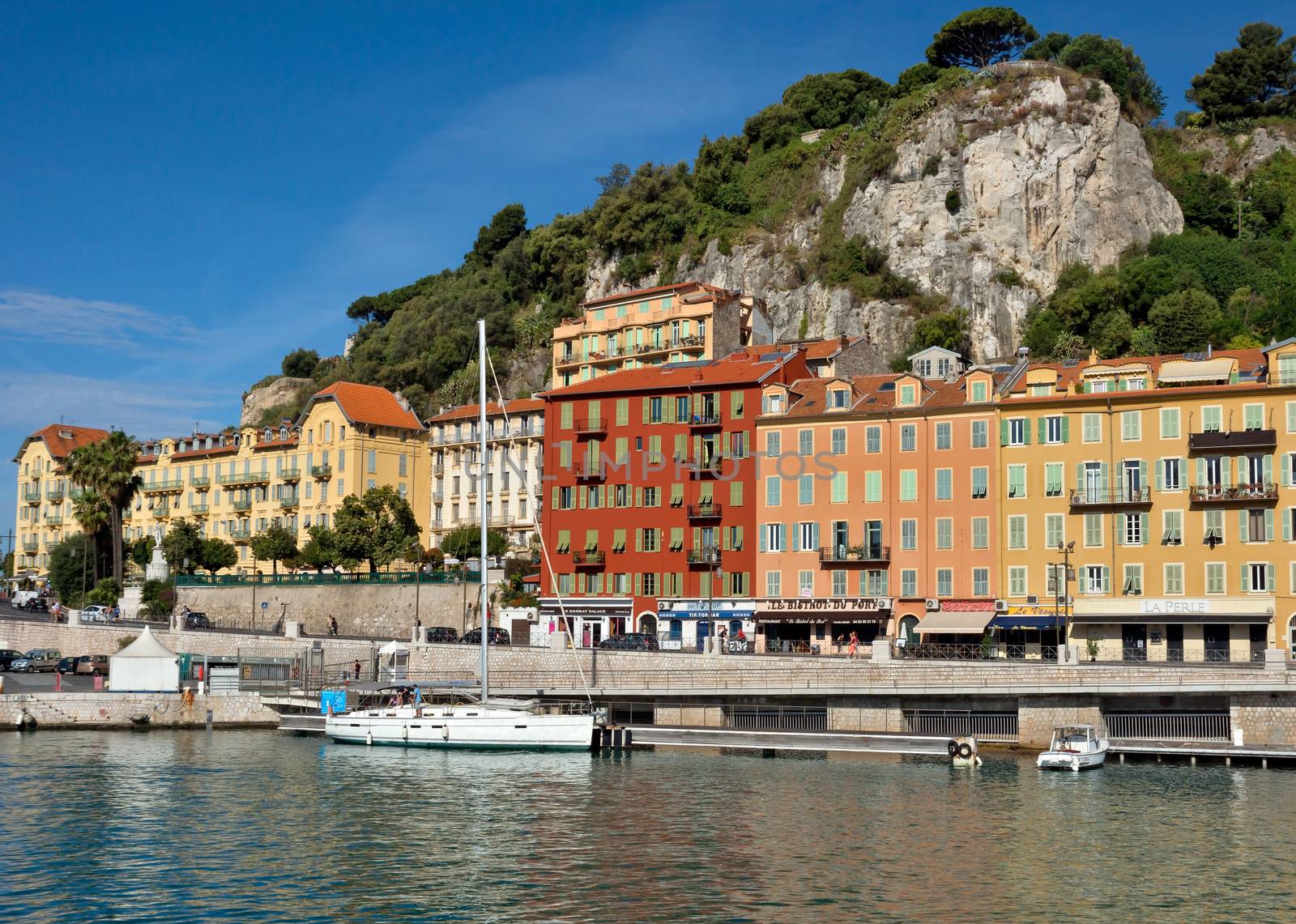 NICE, FRANCE - JUNE 5, 2014: Architecture of city in the Port de Nice in French Riviera. Port de Nice was started in 1745.

Nice, France - June 5, 2014: Architecture of city in the Port de Nice in French Riviera. Port de Nice was started in 1745. People are walking by street.