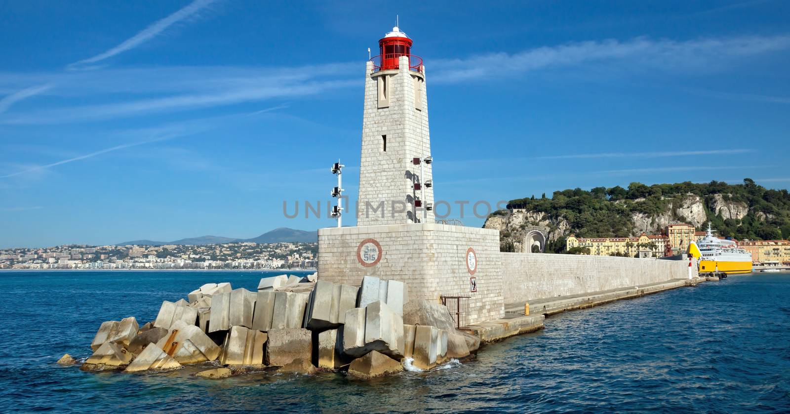 Lighthouse tower at port entrance in city of Nice, France. Port de Nice was started in 1745.
