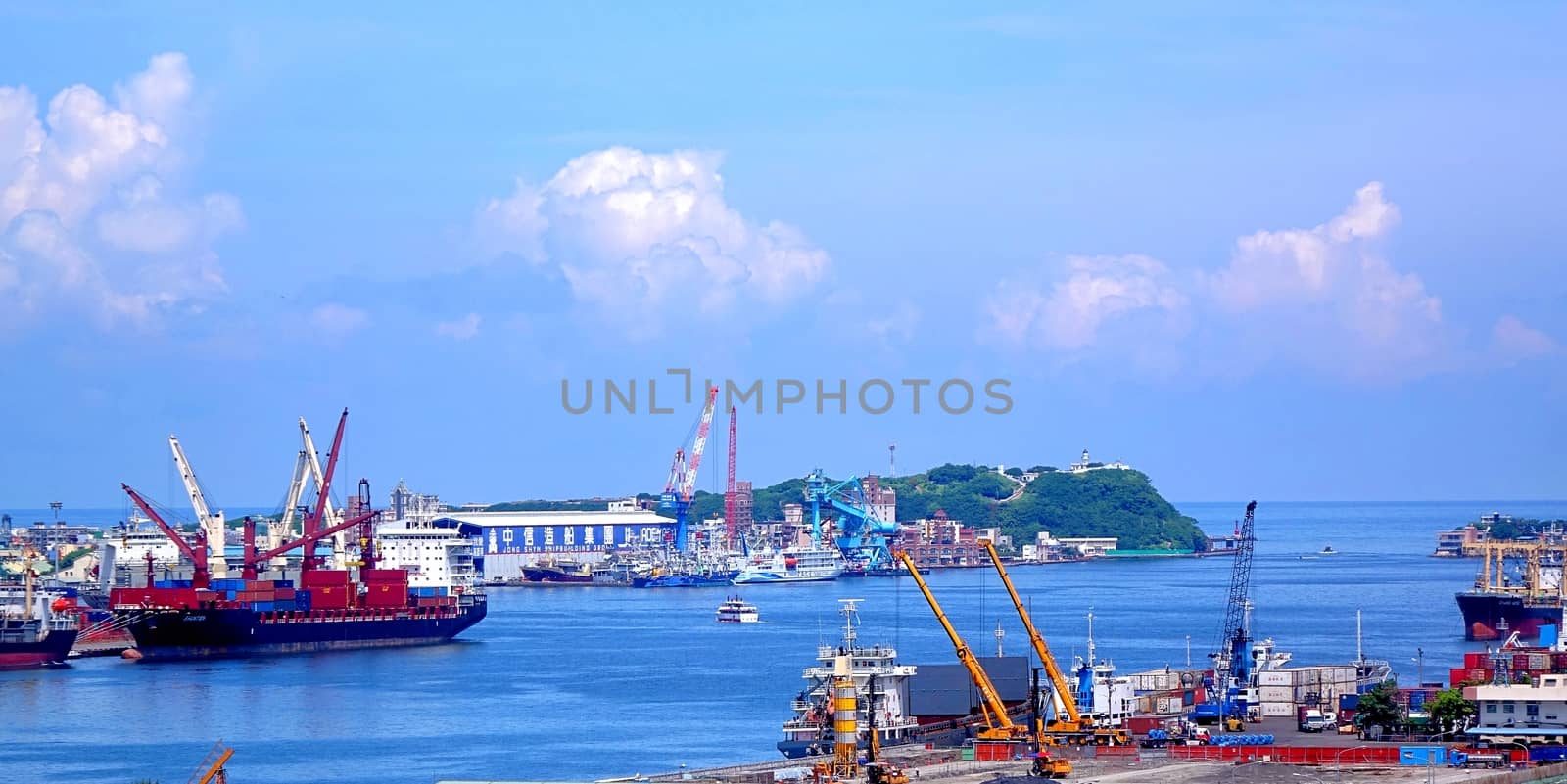 KAOHSIUNG, TAIWAN -- JUNE 11, 2015: A view of the entrance to Kaohsiung Harbor with the old Chijin lighthouse on the back.
