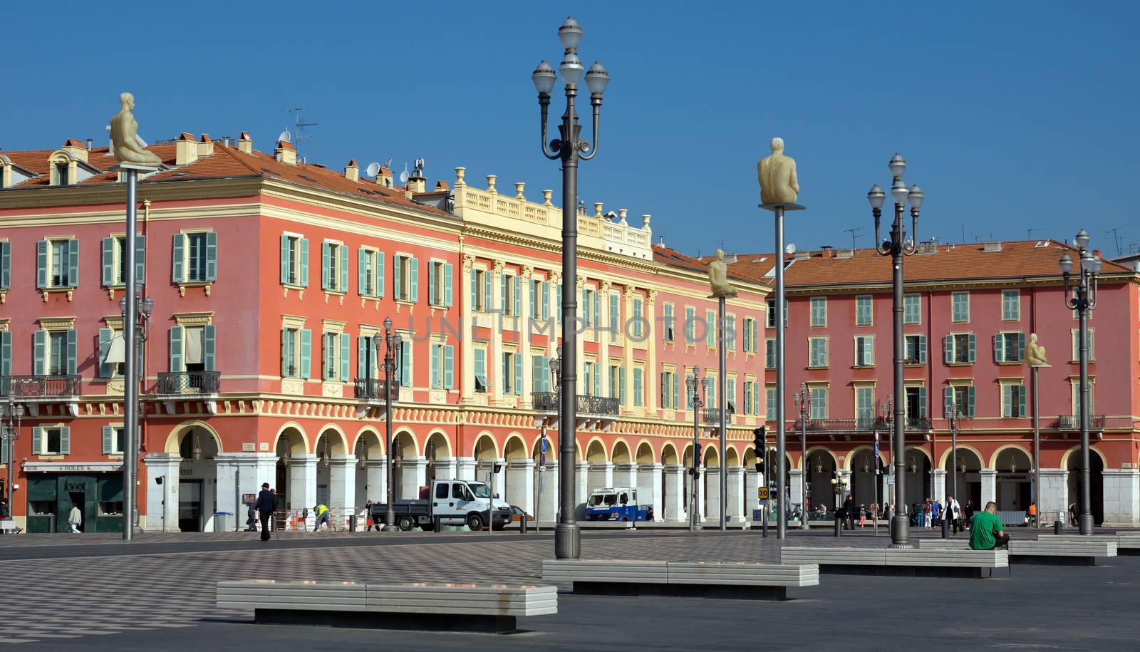 NICE, FRANCE - JUNE 3, 2014: Views of the Place Massena. Square is located in the city center and is the most popular destination among tourists. There are many boutiques, cafes and restaurants.

Nice, France - June 3, 2014: Views of the Place Massena. Square is located in the city center and is the most popular destination among tourists. There are many boutiques, cafes and restaurants. People are walking thru scuare.