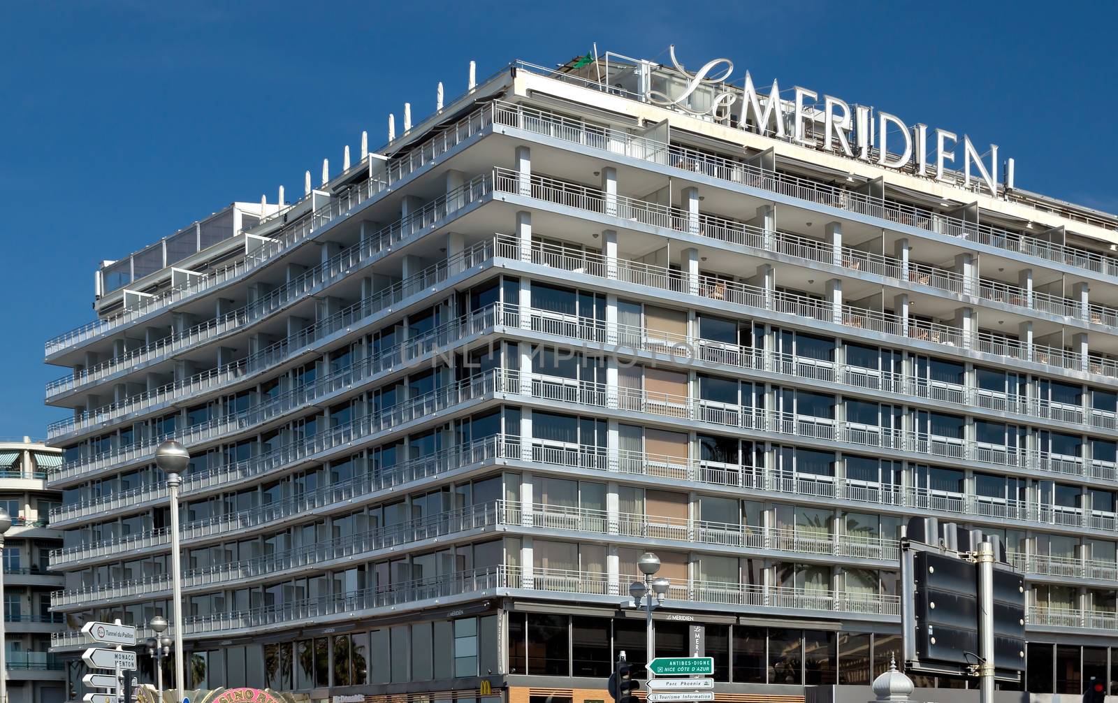 NICE, FRANCE - JUNE 6, 2014: Hotel Le Meridien is located on Promenade des Anglais. Hotel Le Meridien is a symbol of the Cote d'Azur. Built in 1974.

Nice, France - June 6, 2014: Hotel Le Meridien is located on Promenade des Anglais. Hotel Le Meridien is a symbol of the Cote d'Azur. Built in 1974.