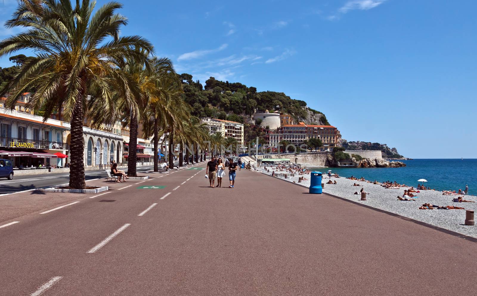 NICE, FRANCE - JUNE 3, 2014: Pedestrians walking on Promenade des Anglais. Promenade des Anglais is a symbol of the Cote d'Azur and was built in 1830 at the expense of the British colony.

Nice, France - June 3, 2014: Pedestrians walking on Promenade des Anglais. Promenade des Anglais is a symbol of the Cote d'Azur and was built in 1830 at the expense of the British colony. People are walking and running by Promenade.