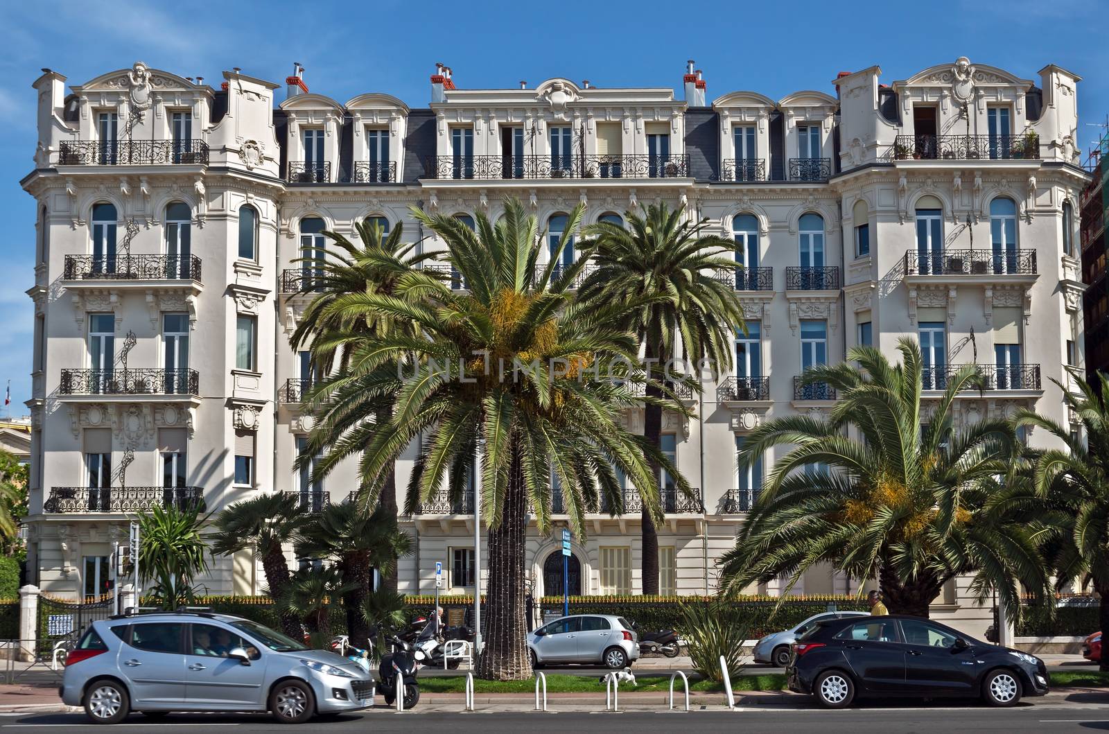 NICE, FRANCE - JUNE 6, 2014: Architecture along Promenade des Anglais. Promenade des Anglais is a symbol of the Cote d'Azur and was built in 1830 at the expense of the British colony.

Nice, France - June 6, 2014: Architecture along Promenade des Anglais. Promenade des Anglais is a symbol of the Cote d'Azur and was built in 1830 at the expense of the British colony.