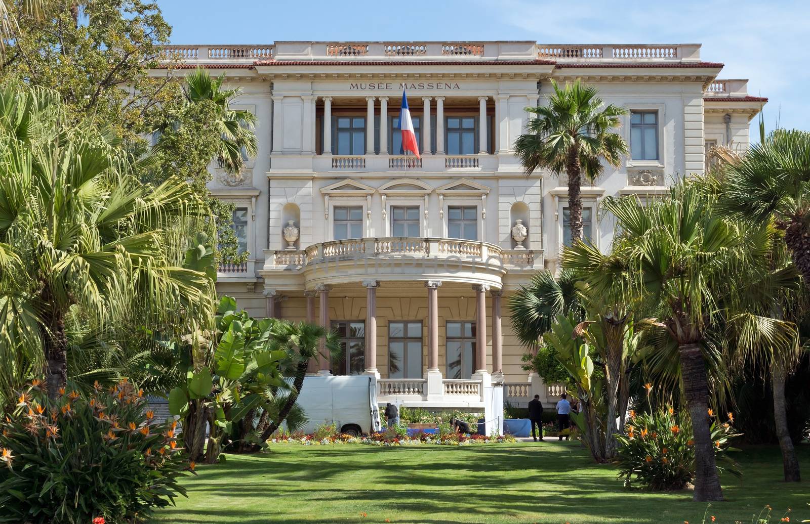 NICE, FRANCE - JUNE 6, 2014: The Massena Palace Museum of Art and History. It is one of the main sights along Promenade des Anglais. 

Nice, France - June 6, 2014: The Massena Palace Museum of Art and History. It is one of the main sights along Promenade des Anglais. People are standing in the garden.