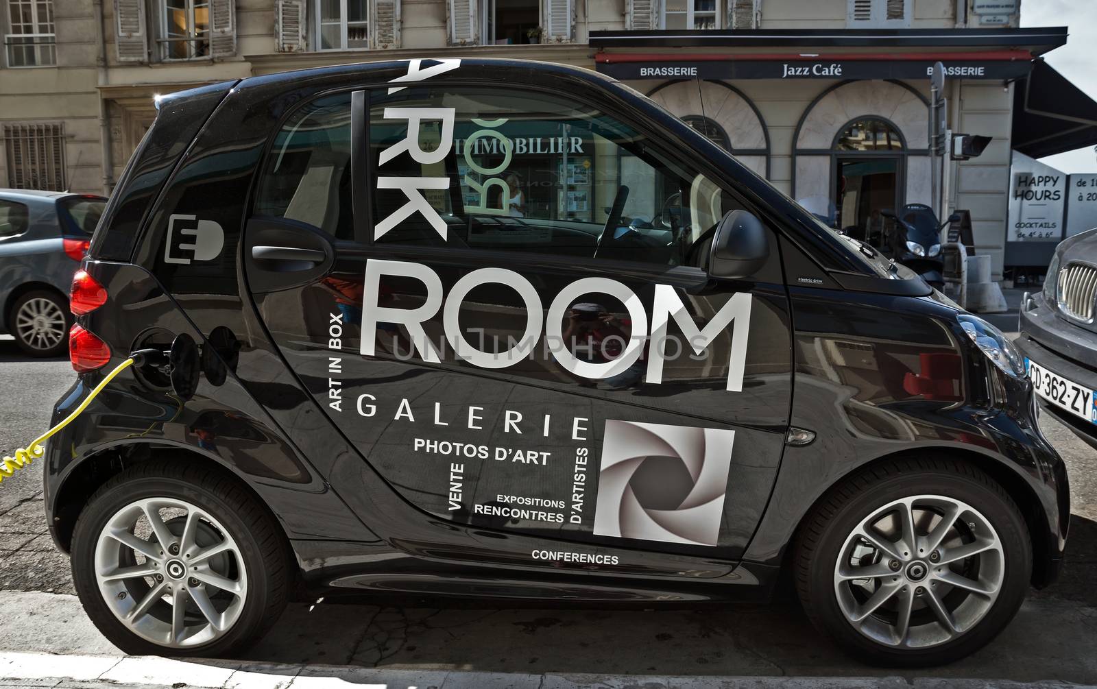 NICE, FRANCE - JUNE 6, 2014: Smart electric drive cars charging at on-street stations.

Nice, France - June 6, 2014: Smart electric drive cars charging at on-street stations. Electric car charging on a street in the center of Nice.