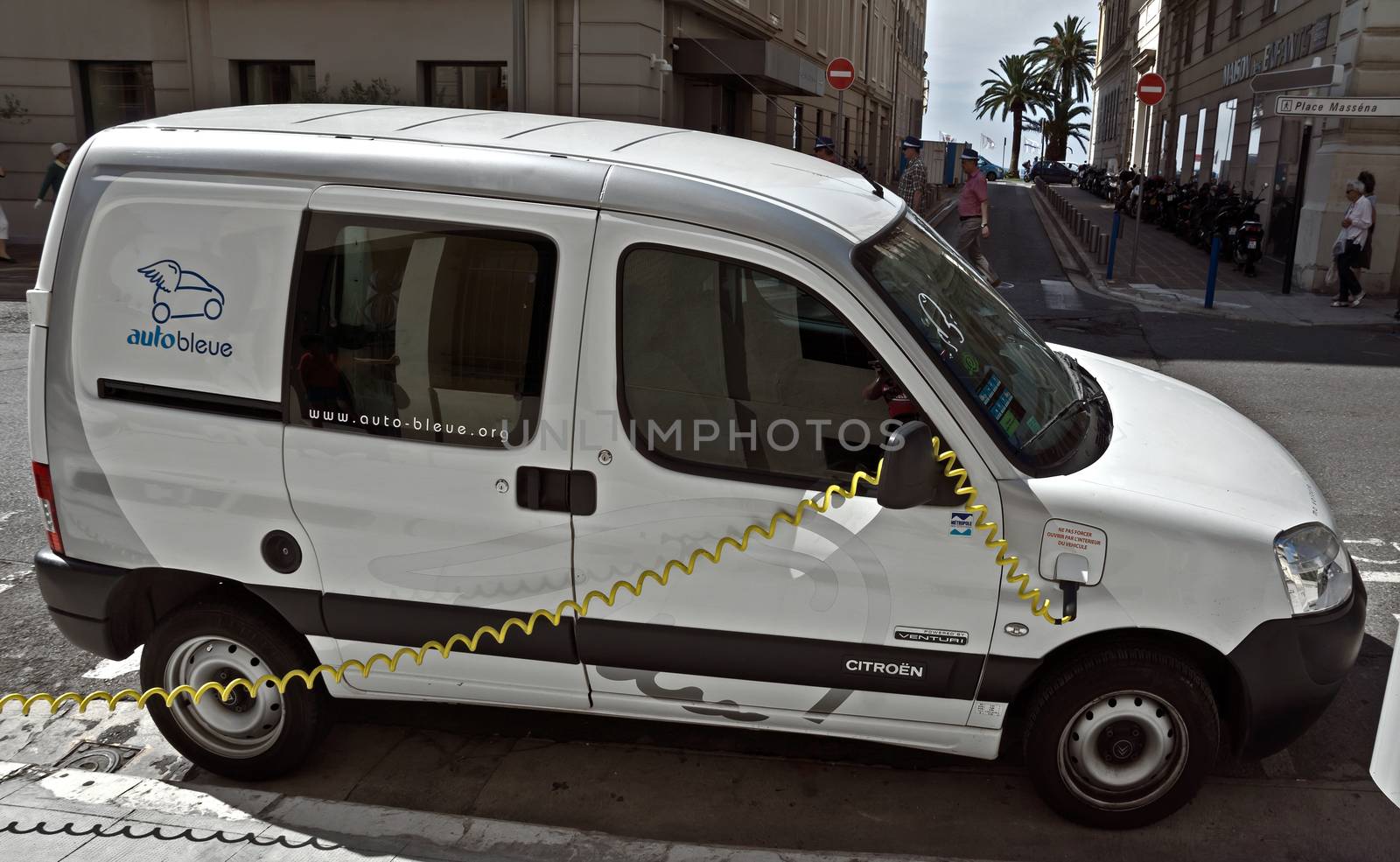 NICE, FRANCE - JUNE 6, 2014: Smart electric drive cars charging at on-street stations.

Nice, France - June 6, 2014: Smart electric drive cars charging at on-street stations. Electric car charging on a street in the center of Nice.