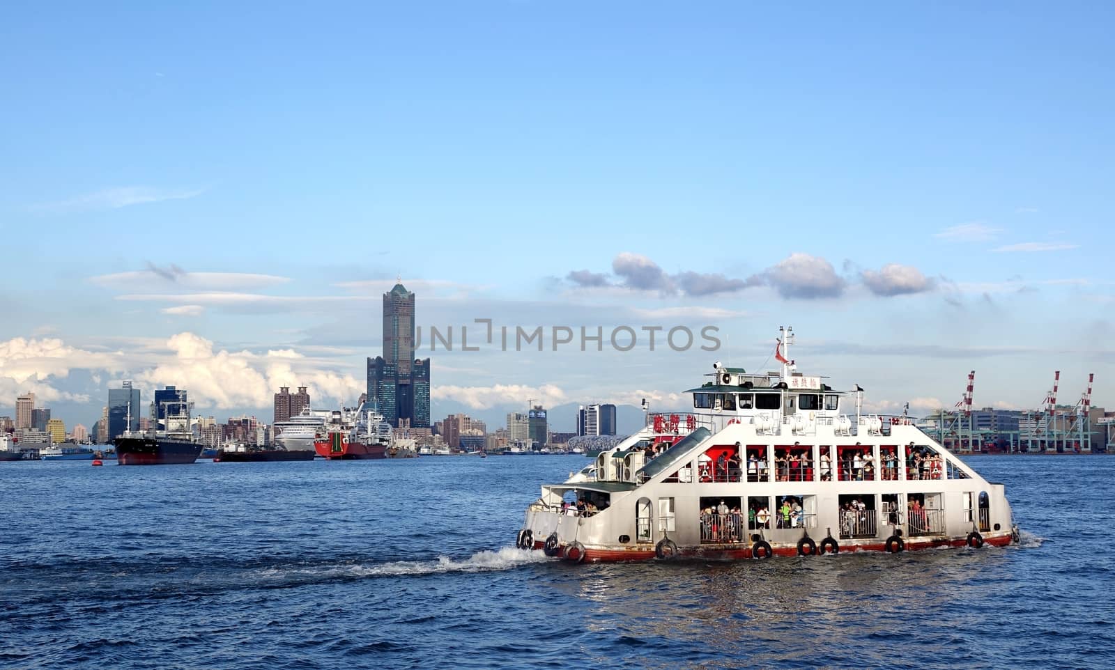 KAOHSIUNG, TAIWAN -- MAY 11, 2014: A panoramic view of Kaohsiung city and port with the cross-harbor ferry in the foreground