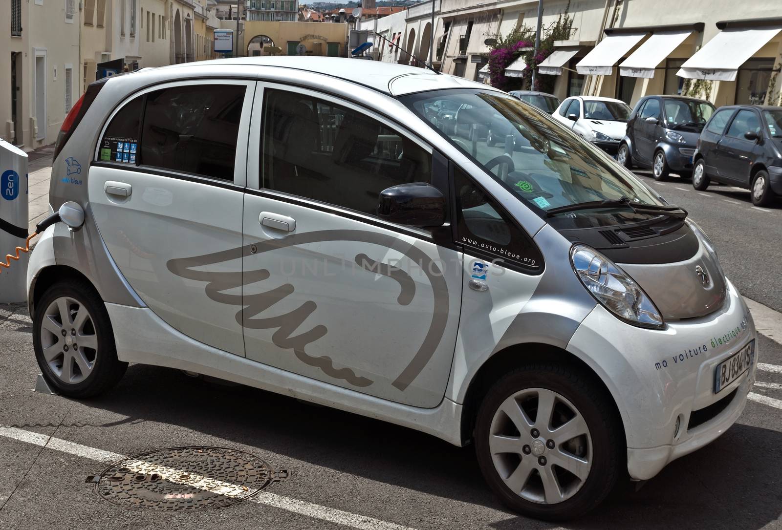 NICE, FRANCE - JUNE 6, 2014: Smart electric drive cars charging at on-street stations.

Nice, France - June 6, 2014: Smart electric drive cars charging at on-street stations. Electric car charging on a street in the center of Nice.