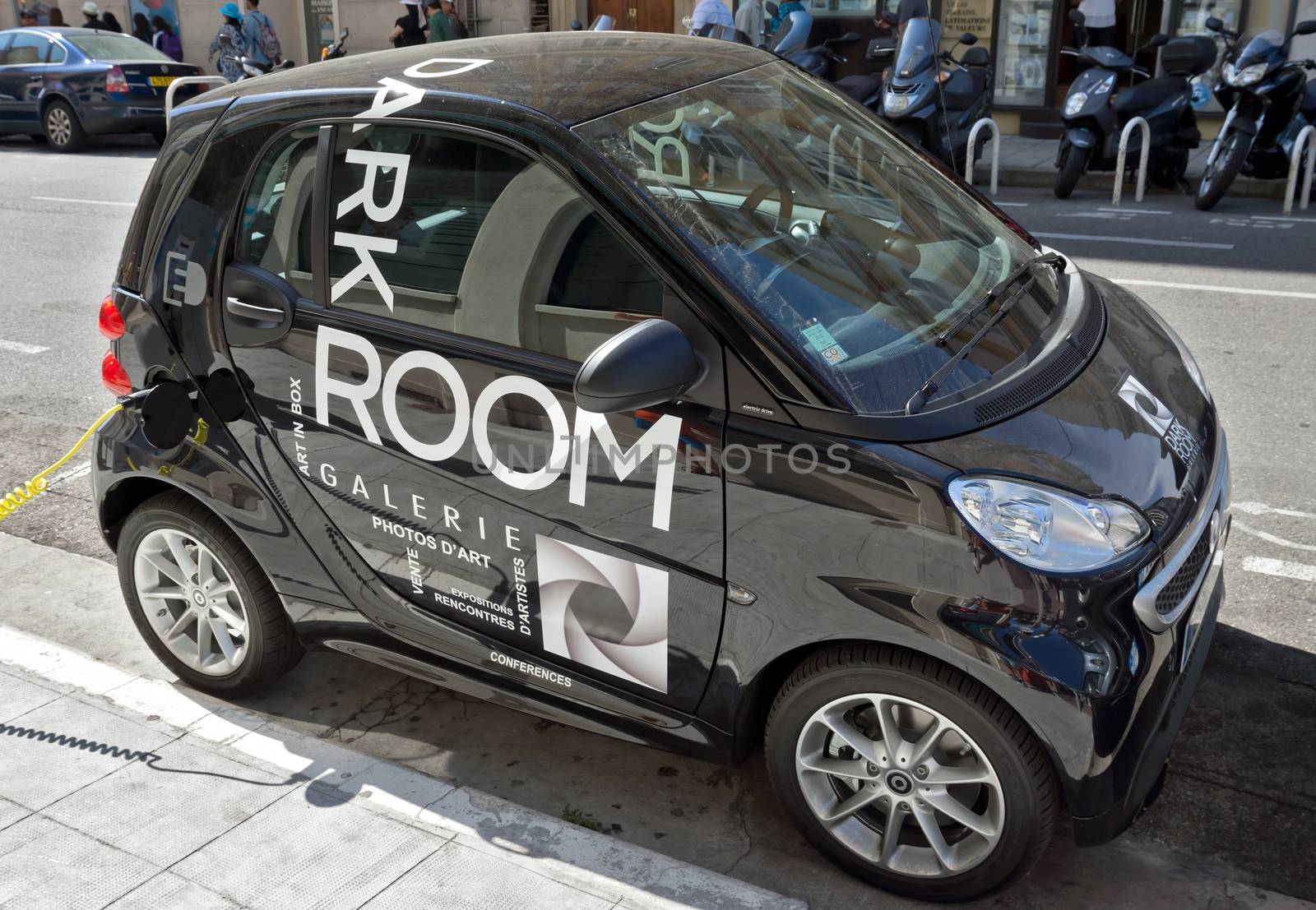 NICE, FRANCE - JUNE 6, 2014: Smart electric drive cars charging at on-street stations.

Nice, France - June 6, 2014: Smart electric drive cars charging at on-street stations. Electric car charging on a street in the center of Nice.