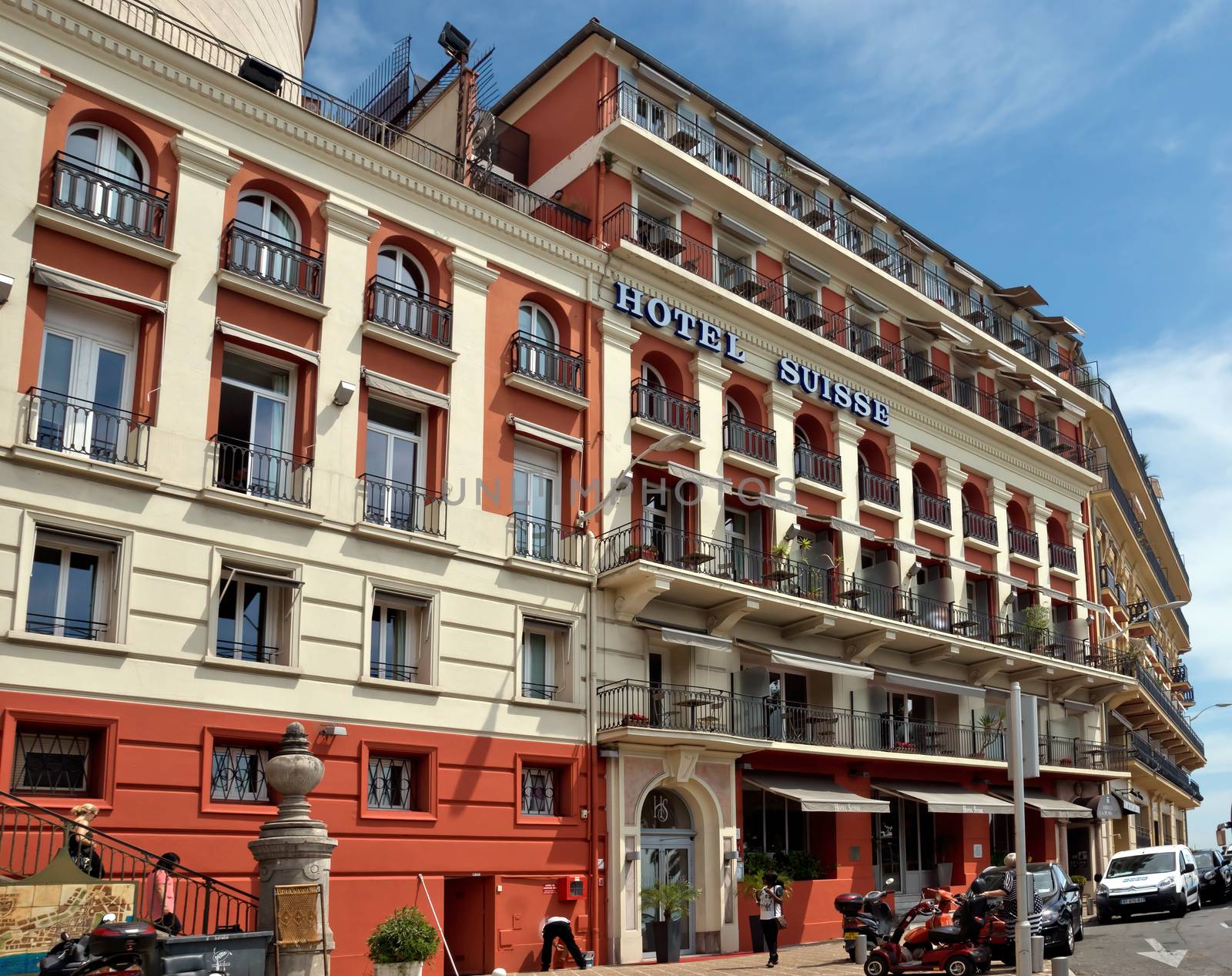 NICE, FRANCE - JUNE 6, 2014: Architecture along Promenade des Anglais. Promenade des Anglais is a symbol of the Cote d'Azur and was built in 1830 at the expense of the British colony.

Nice, France - June 6, 2014: Architecture along Promenade des Anglais. Promenade des Anglais is a symbol of the Cote d'Azur and was built in 1830 at the expense of the British colony. People are walking by street.