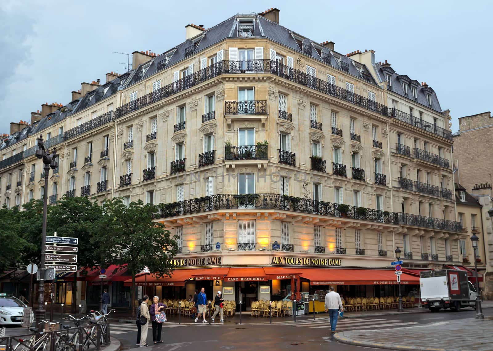 PARIS, FRANCE - JUNE 9, 2014: View of the typical french architecture.

Paris, France - June 9, 2014: View of the typical french architecture. People are walking by street.