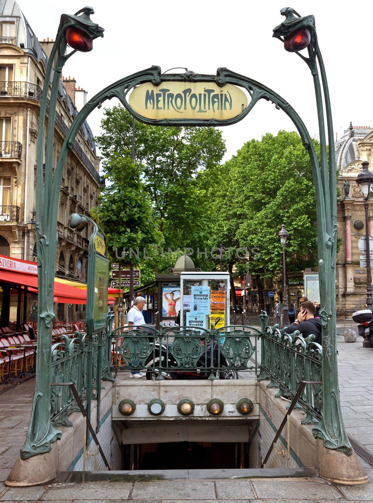 PARIS, FRANCE - JUNE 9: Entrance to the subway, in the style of Art Deco on June 9, 2014 in Paris, France. 

Paris, France - June 9, 2014: Entrance to the subway, in the style of Art Deco. People are standing near entrance to subway.