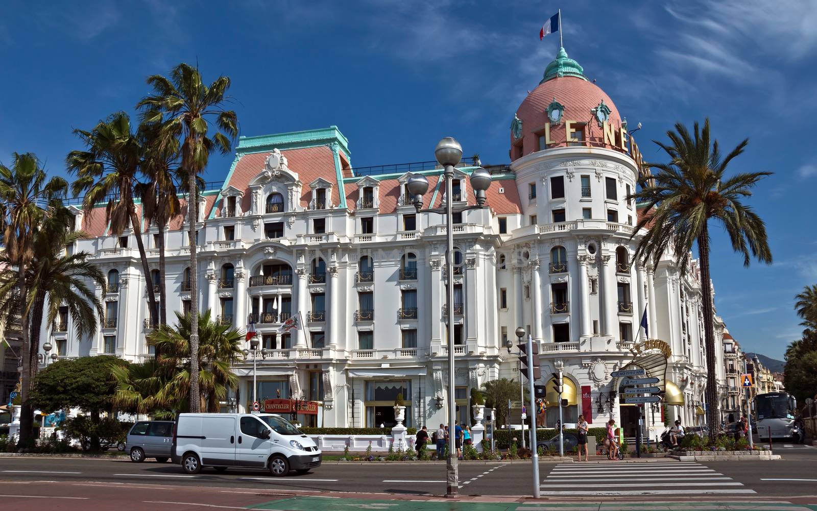 NICE, FRANCE - JUNE 6, 2014: Luxury Hotel Negresco on English Promenade in Nice, French Riviera. Hotel Negresco is the famous luxury hotel on the Promenade des Anglais in Nice, a symbol of the Cote d'Azur.

Nice, France - June 6, 2014: Luxury Hotel Negresco on English Promenade in Nice, French Riviera. Hotel Negresco is the famous luxury hotel on the Promenade des Anglais in Nice, a symbol of the Cote d'Azur. People are walking by street.