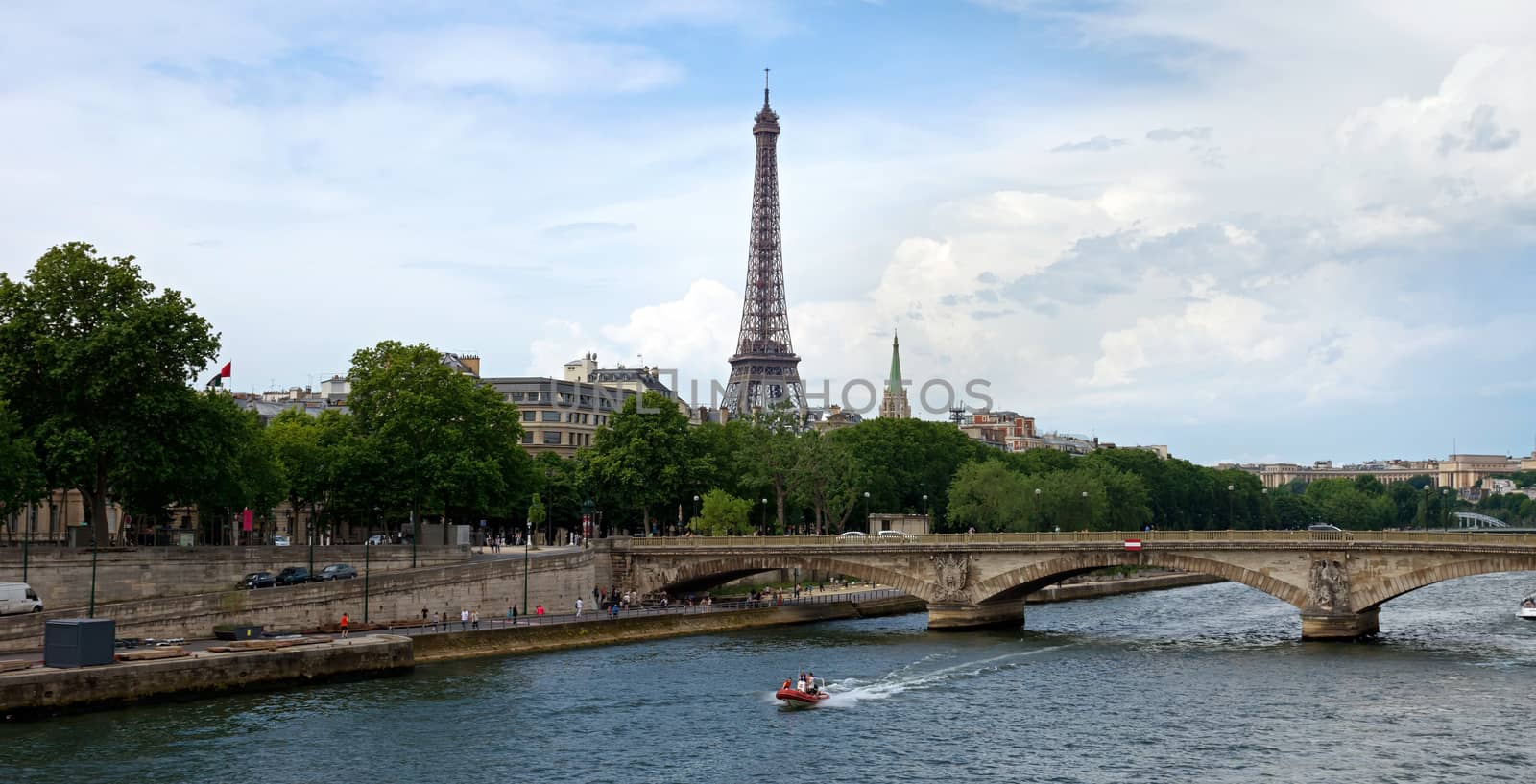A view of the Eiffel Tower with a bridge in the foreground. Paris, France.