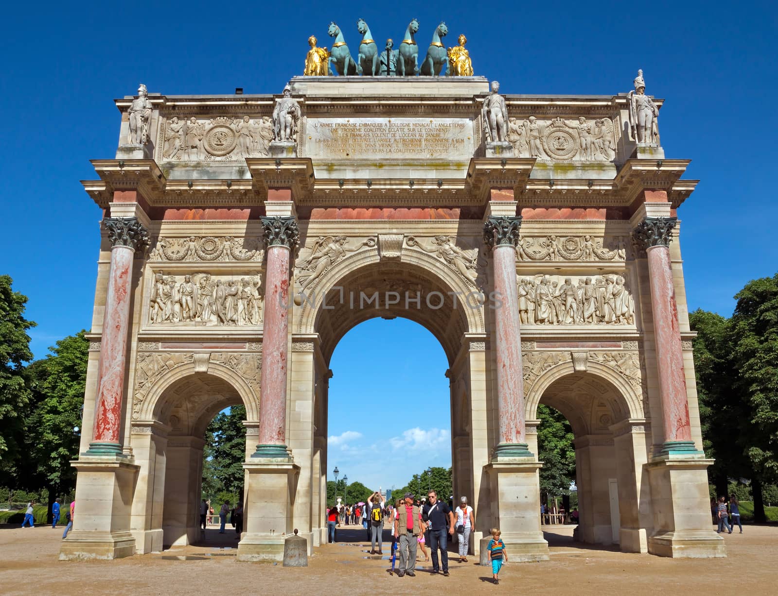 PARIS, FRANCE - JUNE 9: Triumphal Arch (Arc de Triomphe du Carrousel) at Tuileries gardens. Monument was built between 1806-1808 to commemorate Napoleon's military victories.

Paris, France - June 9, 2014: Triumphal Arch (Arc de Triomphe du Carrousel) at Tuileries gardens in Paris, France. Monument was built between 1806-1808 to commemorate Napoleon's military victories. People are walking through Arch.