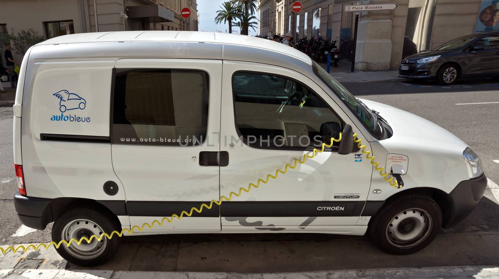 NICE, FRANCE - JUNE 6, 2014: Smart electric drive cars charging at on-street stations.

Nice, France - June 6, 2014: Smart electric drive cars charging at on-street stations. Electric car charging on a street in the center of Nice.
