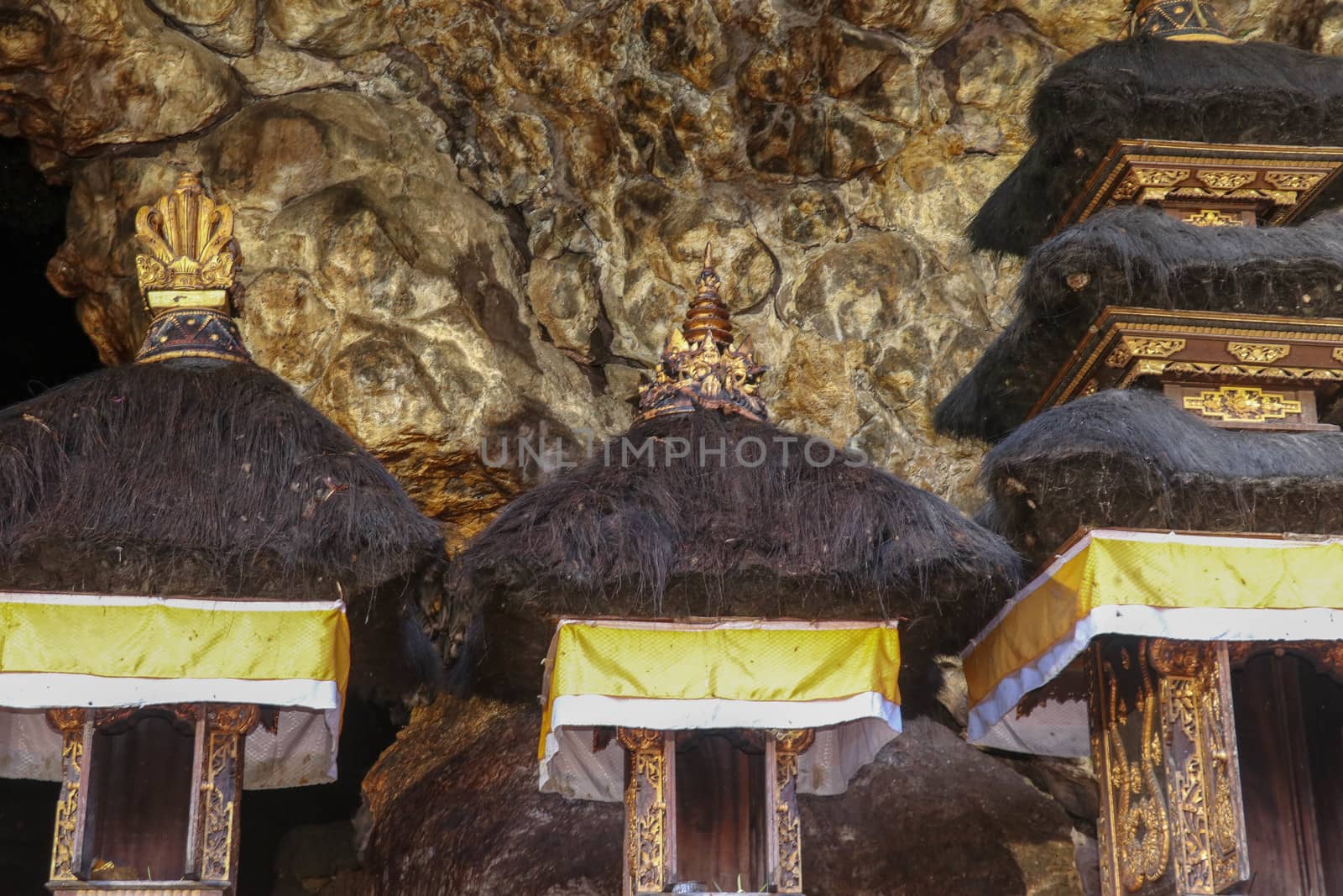 Altars at Pura Goa Lawah or Bat Cave Temple. Balinese Hindu temple in Pesinggahan, Klungkung, Bali, Indonesia. Many bats hanging from the ceiling of the Cave of bats. Colony of bats are waiting dark.
