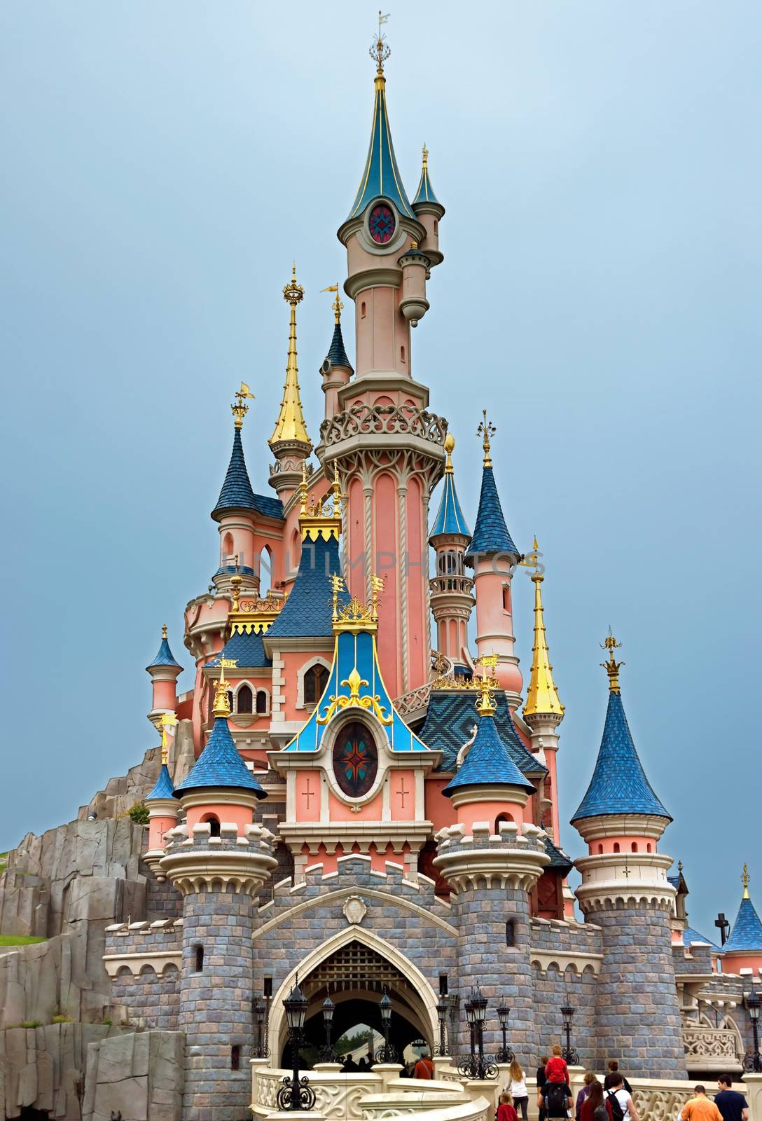 Paris, France - June 10, 2014: Sleeping Beauty Castle in Disneyland park. Disneyland Paris one of Europe's most popular attraction. People go to the castle.