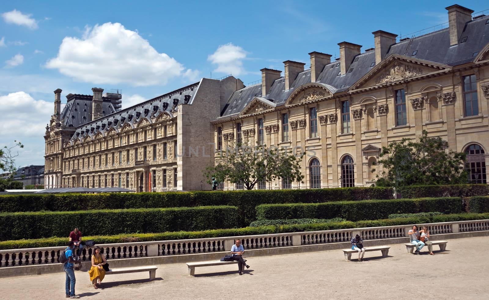 PARIS, FRANCE - JUNE 11, 2014: Famous "jardin des Tuileries" in Paris, France.

Paris, France - June 11, 2014: Famous "jardin des Tuileries" in Paris, France. People are sitting on benches.