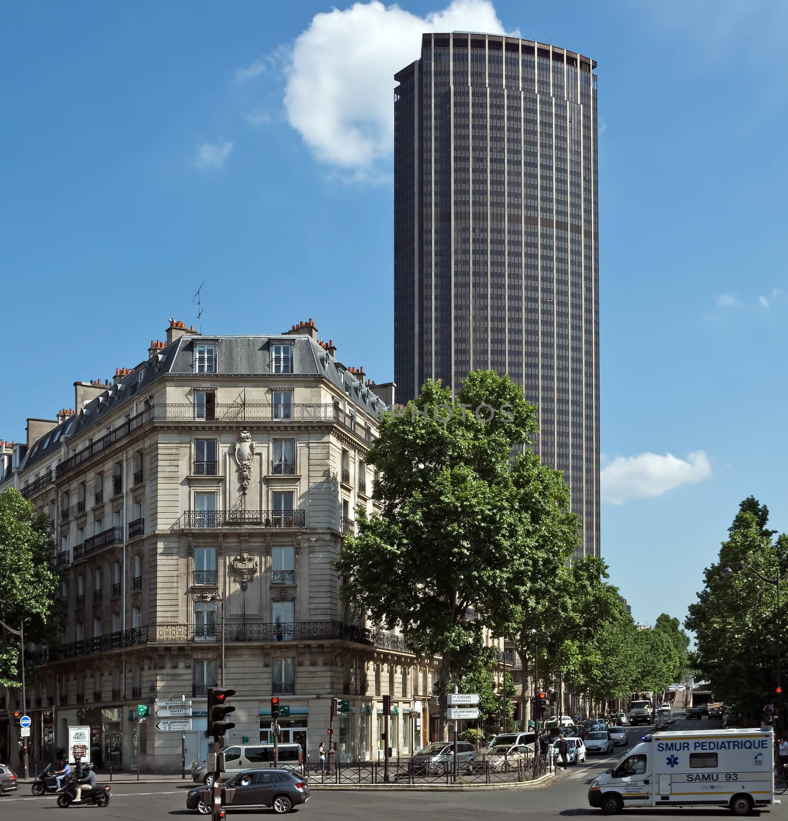 PARIS, FRANCE - JUNE 11, 2014: The architecture of the old and modern Paris. View of old building and Tour Montparnasse. Tour Montparnasse was constructed 1969 - 1972 by architects Eugene Beaudouin, Urbain Cassan and Louis Hoym de Marien.

Paris, France - June 11, 2014: The architecture of the old and modern Paris. View of old building and Tour Montparnasse. Tour Montparnasse was constructed 1969 - 1972 by architects Eugene Beaudouin, Urbain Cassan and Louis Hoym de Marien. People are walking by street.