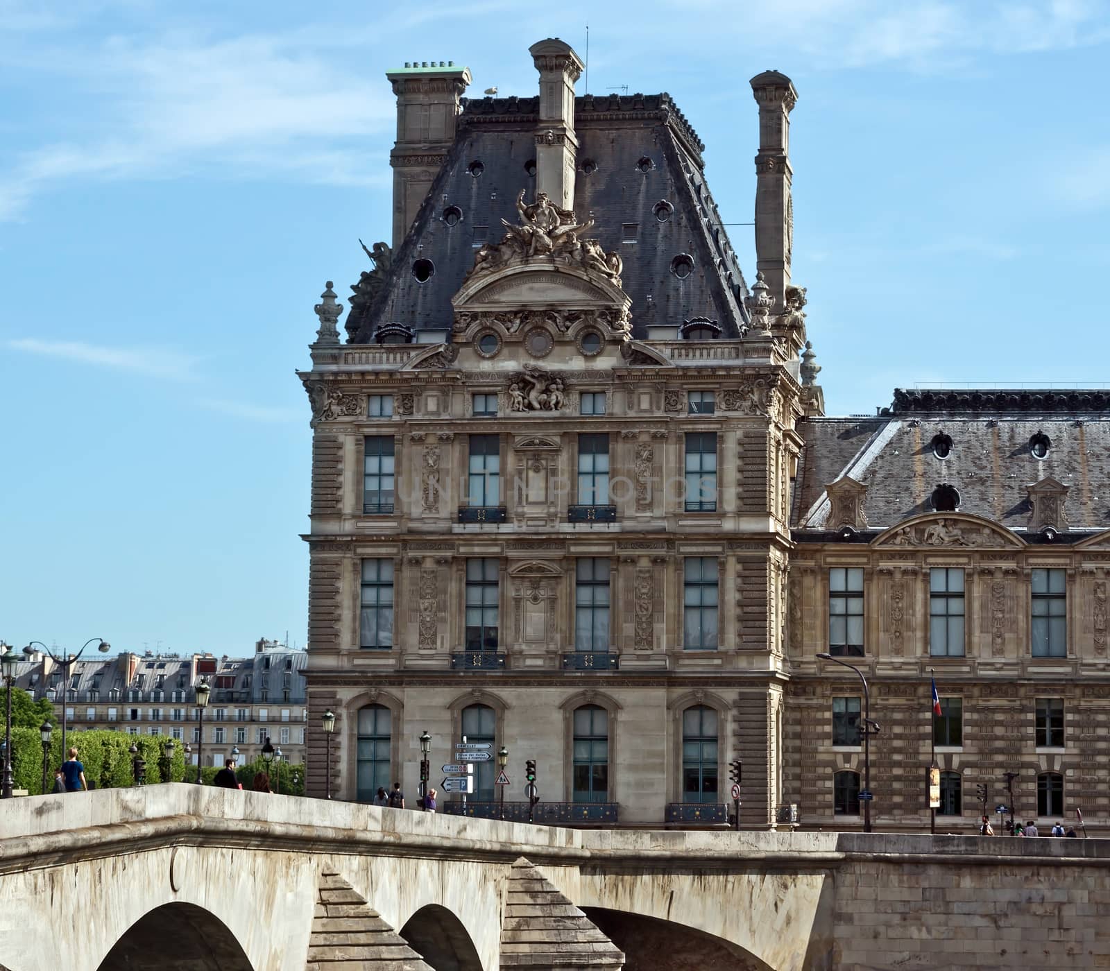 PARIS, FRANCE - JUNE 11, 2014: View of the Louvre. Louvre is one of the biggest Museum in the world, receiving more than 8 million visitors each year.

Paris, France - June 11, 2014: View of the Louvre. Louvre is one of the biggest Museum in the world, receiving more than 8 million visitors each year. People are walking and looking at the sightseeings.