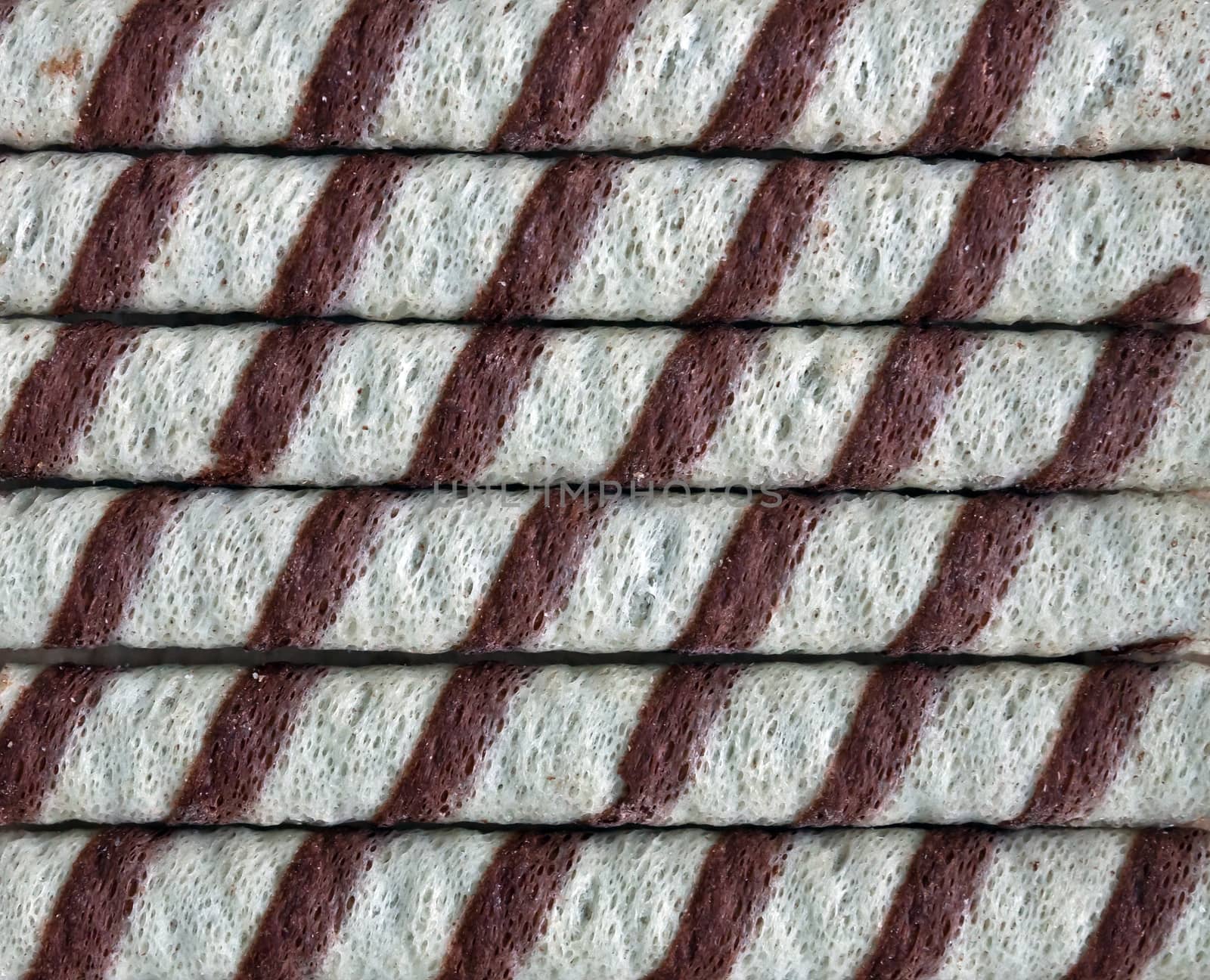 A closeup of chocolate striped wafer rolls