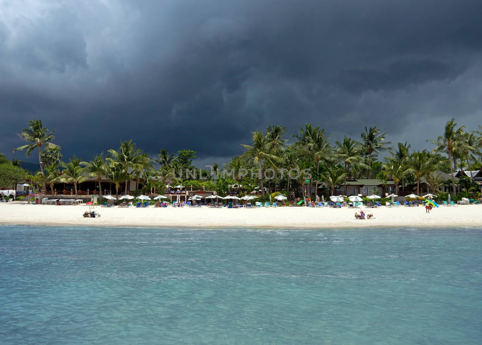 KOH SAMUI, THAILAND - JULY 30: View at the Chaweng Beach before storm on July 30, 2013 in Koh Samui, Thailand. People are sunbathing on the Chaweng beach in Koh Samui.

Koh Samui, Thailand - July 30, 2013: View at the Chaweng Beach before storm. People are sunbathing on the Chaweng beach in Koh Samui.