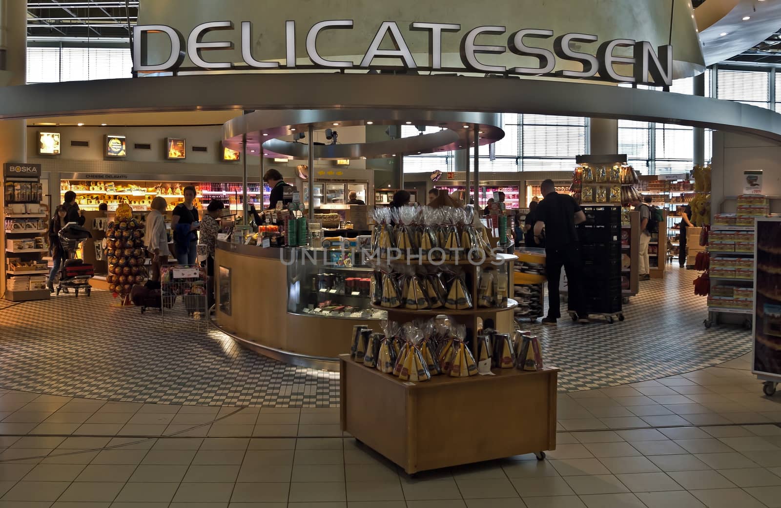 AMSTERDAM SCHIPHOL, THE NETHERLANDS - JUNE 12, 2014: Shopping center Schiphol Plaza at Schiphol airport.

Amsterdam Schiphol, The Netherlands - June 12, 2014: Shopping center Schiphol Plaza at Schiphol airport. People are shopping.