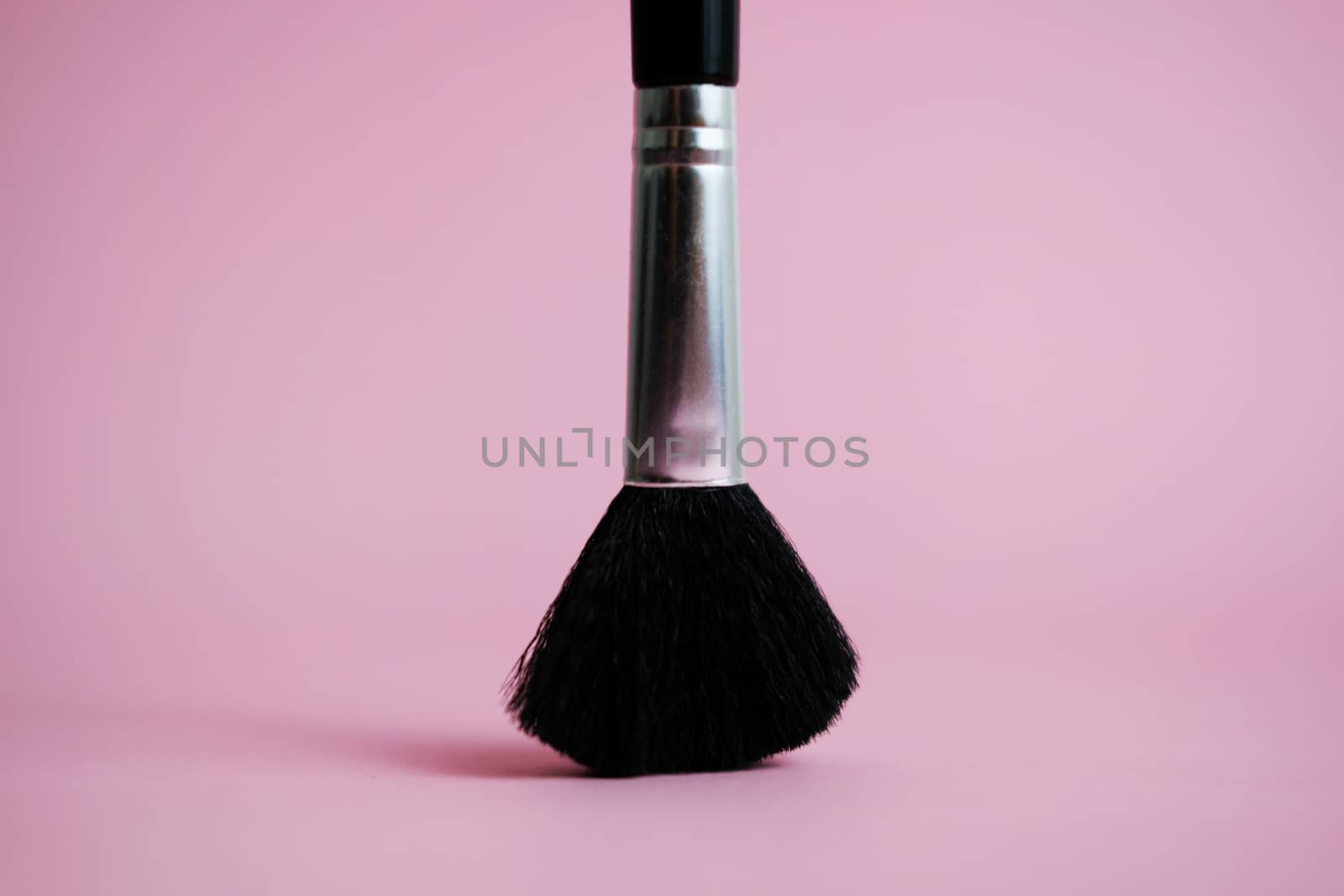 brush makeup tools with pink pastel background. Image photo