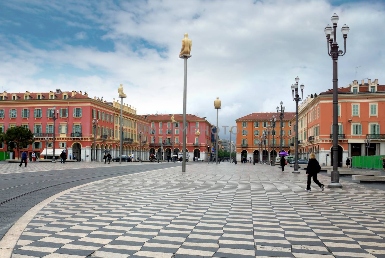 NICE, FRANCE - APRIL 27: The Place Massena on April 27, 2013 in Nice, France. The square was reconstructed in 1979.

Nice, France - April 27, 2013: Views of the Place Massena. Square is located in the city center and is the most popular destination among tourists. There are many boutiques, cafes and restaurants. People are walking thru scuare.