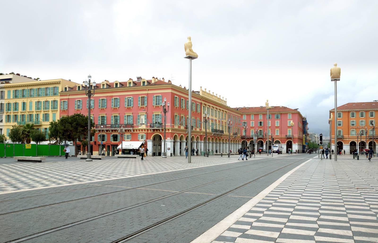 NICE, FRANCE - APRIL 27: The Place Massena on April 27, 2013 in Nice, France. The square was reconstructed in 1979.

Nice, France - April 27, 2013: Views of the Place Massena. Square is located in the city center and is the most popular destination among tourists. There are many boutiques, cafes and restaurants. People are walking thru scuare.