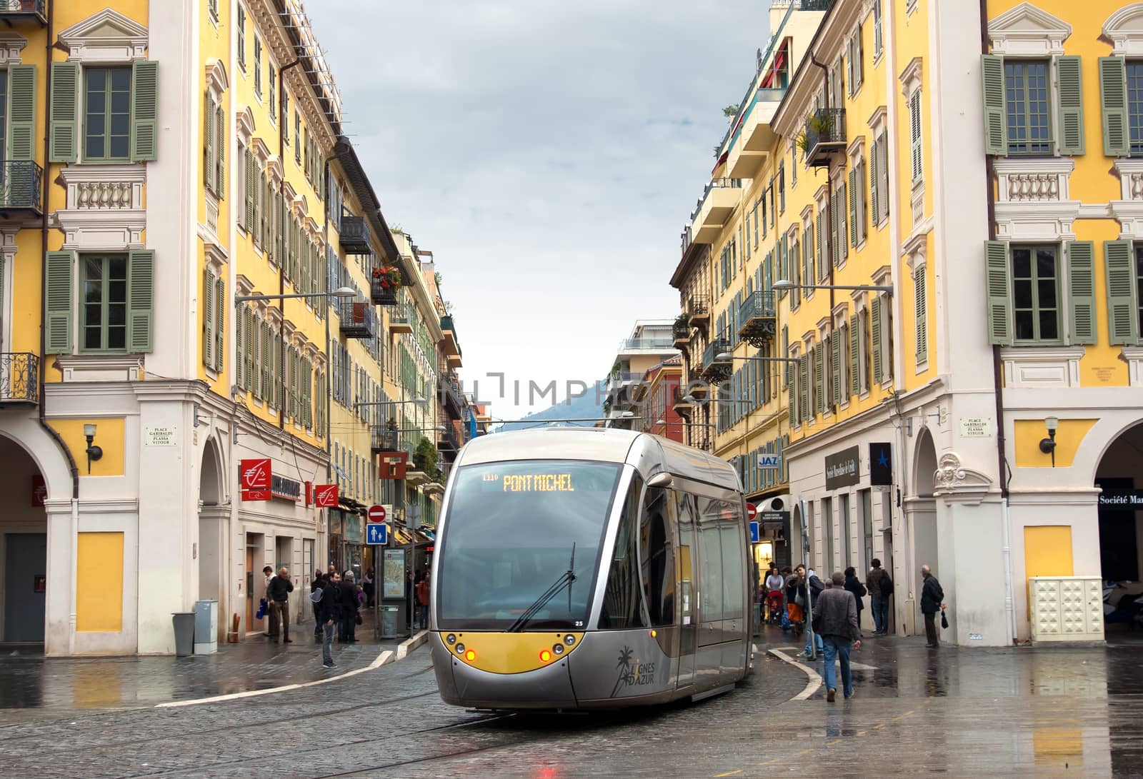NICE, FRANCE - APRIL 26: Modern tram in the center of Nice, France on April 26, 2013. Old Square - Place Garibaldi. The square was built in 1870.

Nice, France - April 26, 2013: Modern tram in the center of city. People are walking along street.