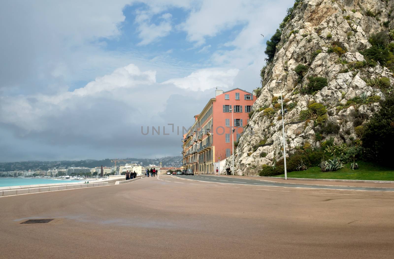 NICE, FRANCE - APRIL 27: Architecture along Promenade des Anglais on April 27, 2013 in Nice, France. It is a symbol of the Cote d'Azur and was built in 1830 at the expense of the British colony.

Nice, France - April 27, 2013: Architecture along Promenade des Anglais. People are walking. Promenade des Anglais is a symbol of the Cote d'Azur and was built in 1830 at the expense of the British colony.