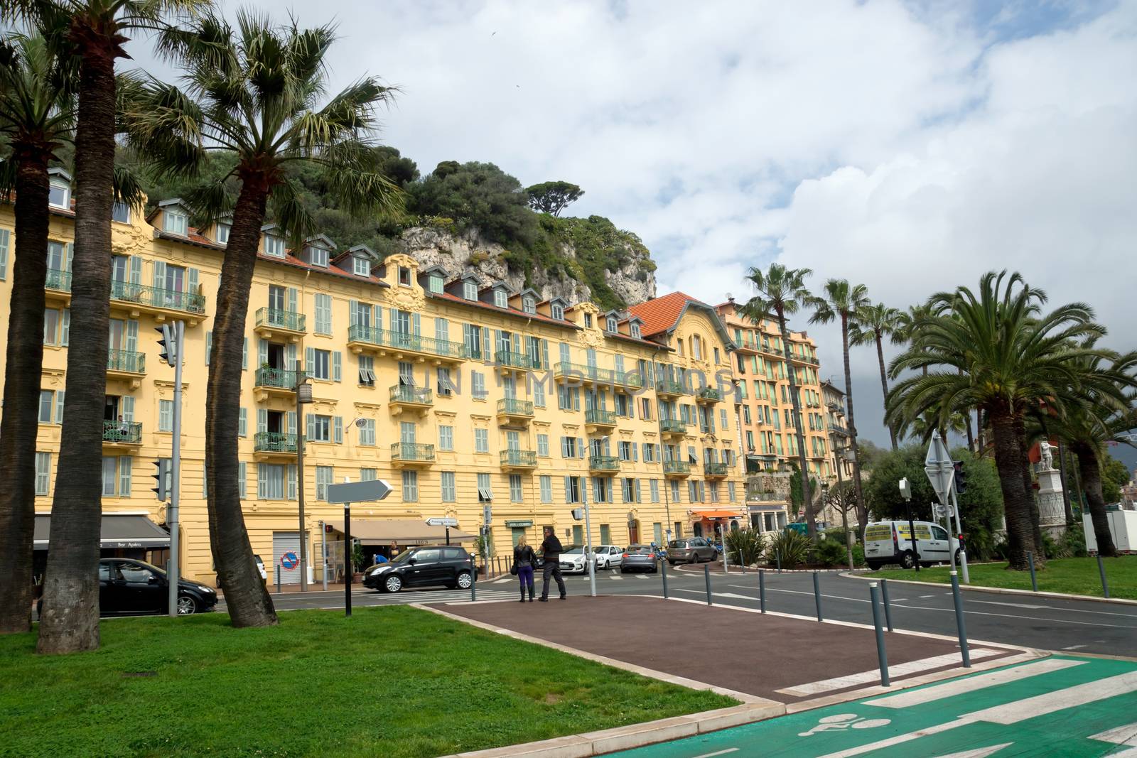 NICE, FRANCE - APRIL 27: Architecture along Promenade des Anglais on April 27, 2013 in Nice, France. It is a symbol of the Cote d'Azur and was built in 1830 at the expense of the British colony.

Nice, France - April 27, 2013: Architecture along Promenade des Anglais. People are walking. Promenade des Anglais is a symbol of the Cote d'Azur and was built in 1830 at the expense of the British colony.