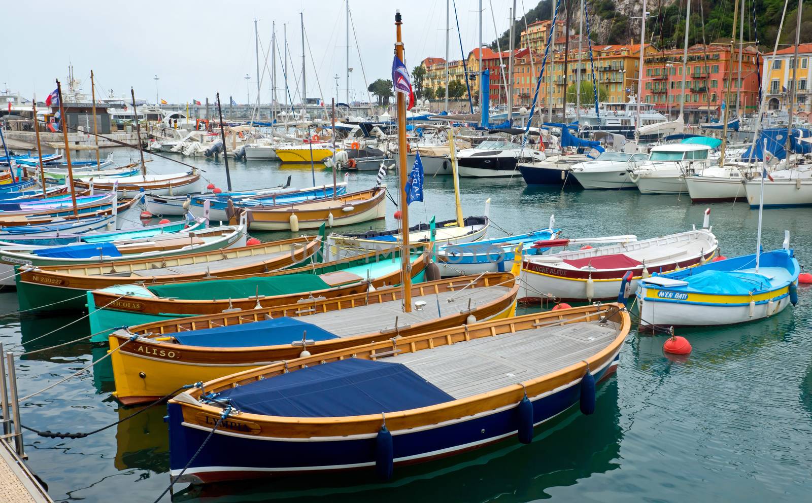 NICE, FRANCE - APRIL 27: Colorful buildings and boats within a Port de Nice on April 27, 2013 in Nice, France. Port de Nice was started in 1745.

Nice, France - April 27, 2013 : Colorful buildings and boats within a Port de Nice in French Riviera. Port de Nice was started in 1745.