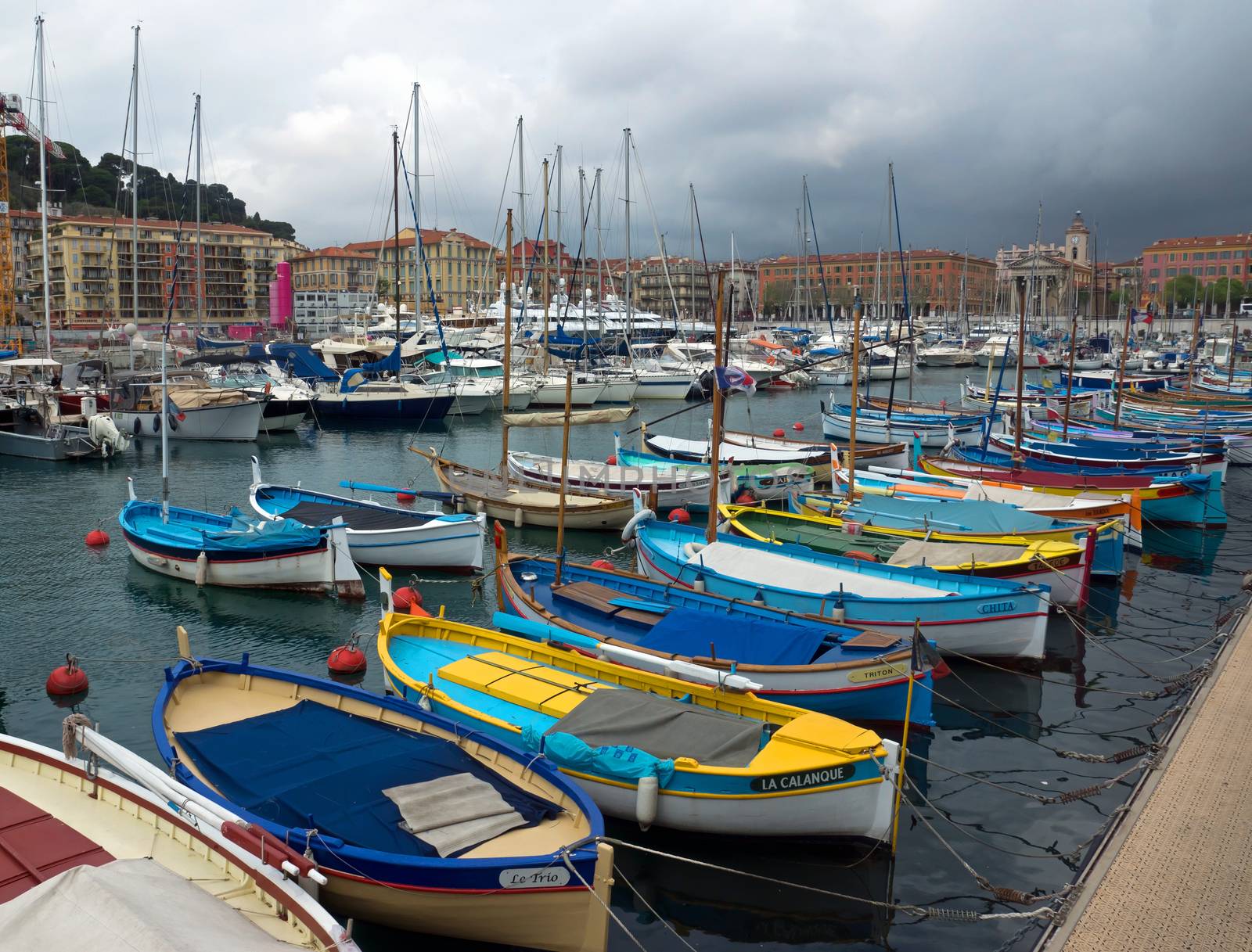 NICE, FRANCE - APRIL 27: Colorful buildings and boats within a Port de Nice on April 27, 2013 in Nice, France. Port de Nice was started in 1745.

Nice, France - April 27, 2013 : Colorful buildings and boats within a Port de Nice in French Riviera. Port de Nice was started in 1745.