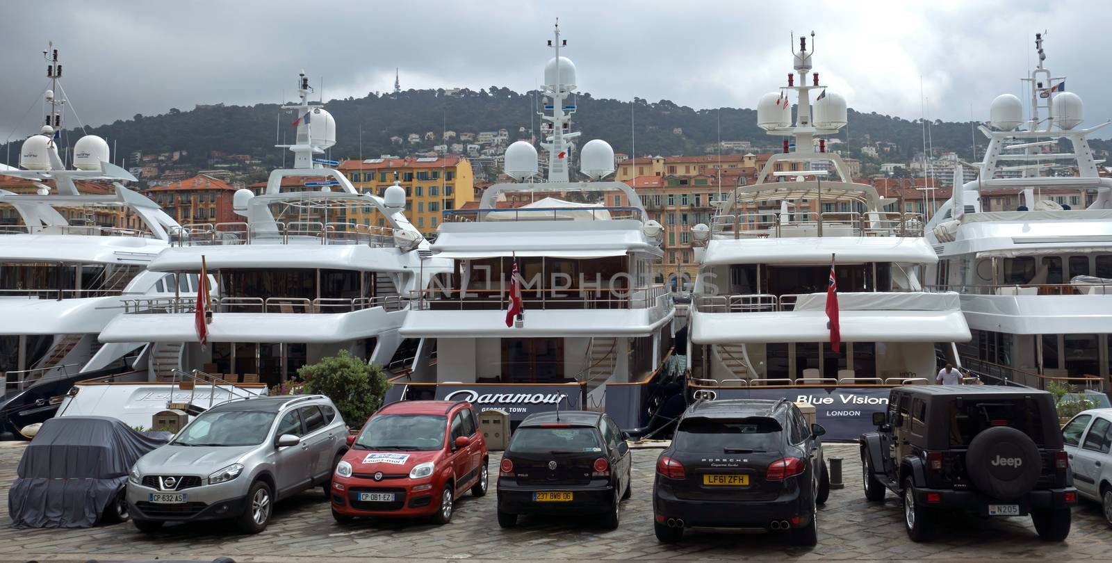 NICE, FRANCE - APRIL 27: Expensive yachts anchored within a Port de Nice on April 27, 2013 in Nice, France. Port de Nice was started in 1745.

Nice, France - April 27, 2013: Expensive yachts anchored within a Port de Nice in French Riviera. Port de Nice was started in 1745.