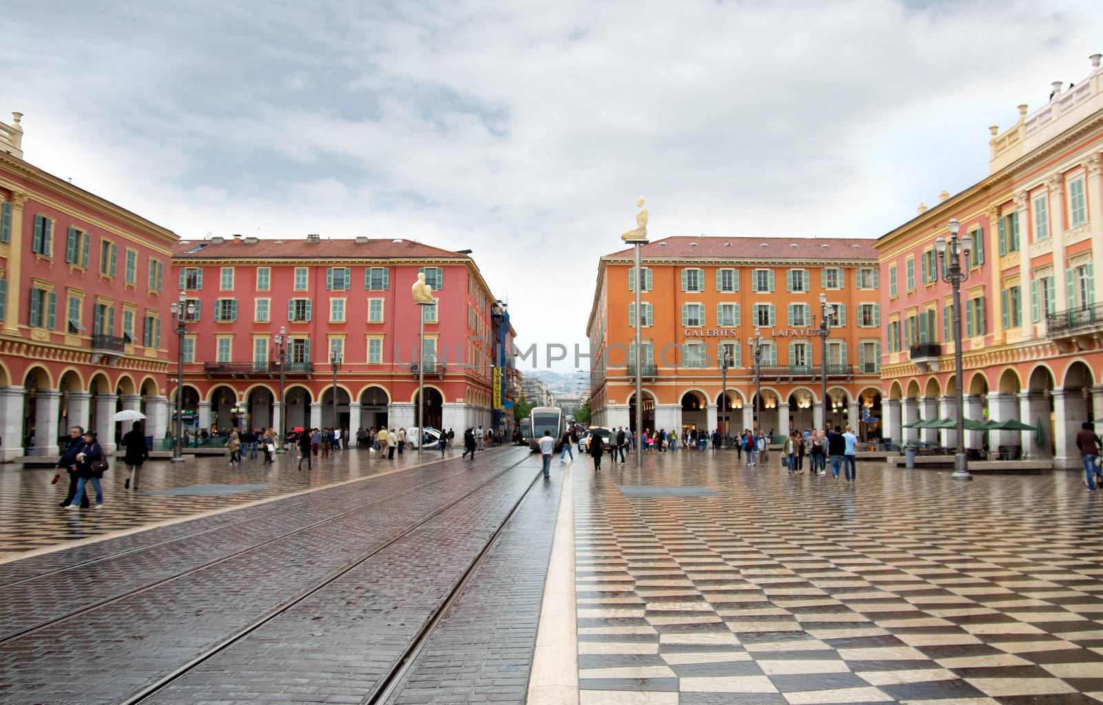 NICE, FRANCE - APRIL 26: The Place Massena on April 26, 2013 in Nice, France. Square is located in the city center and is the most popular destination among tourists. It was reconstructed in 1979.

Nice, France - April 26, 2013: People walking in central square - Place Massena, new landmark of the town.
Place Massena in Nice, France