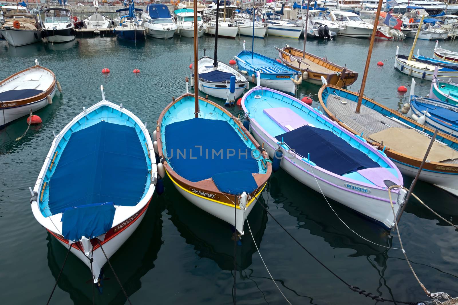 NICE, FRANCE - APRIL 27: Colorful buildings and boats within a Port de Nice on April 27, 2013 in Nice, France. Port de Nice was started in 1745.

Nice, France - April 27, 2013: Colorful buildings and boats within a Port de Nice in French Riviera. Port de Nice was started in 1745.