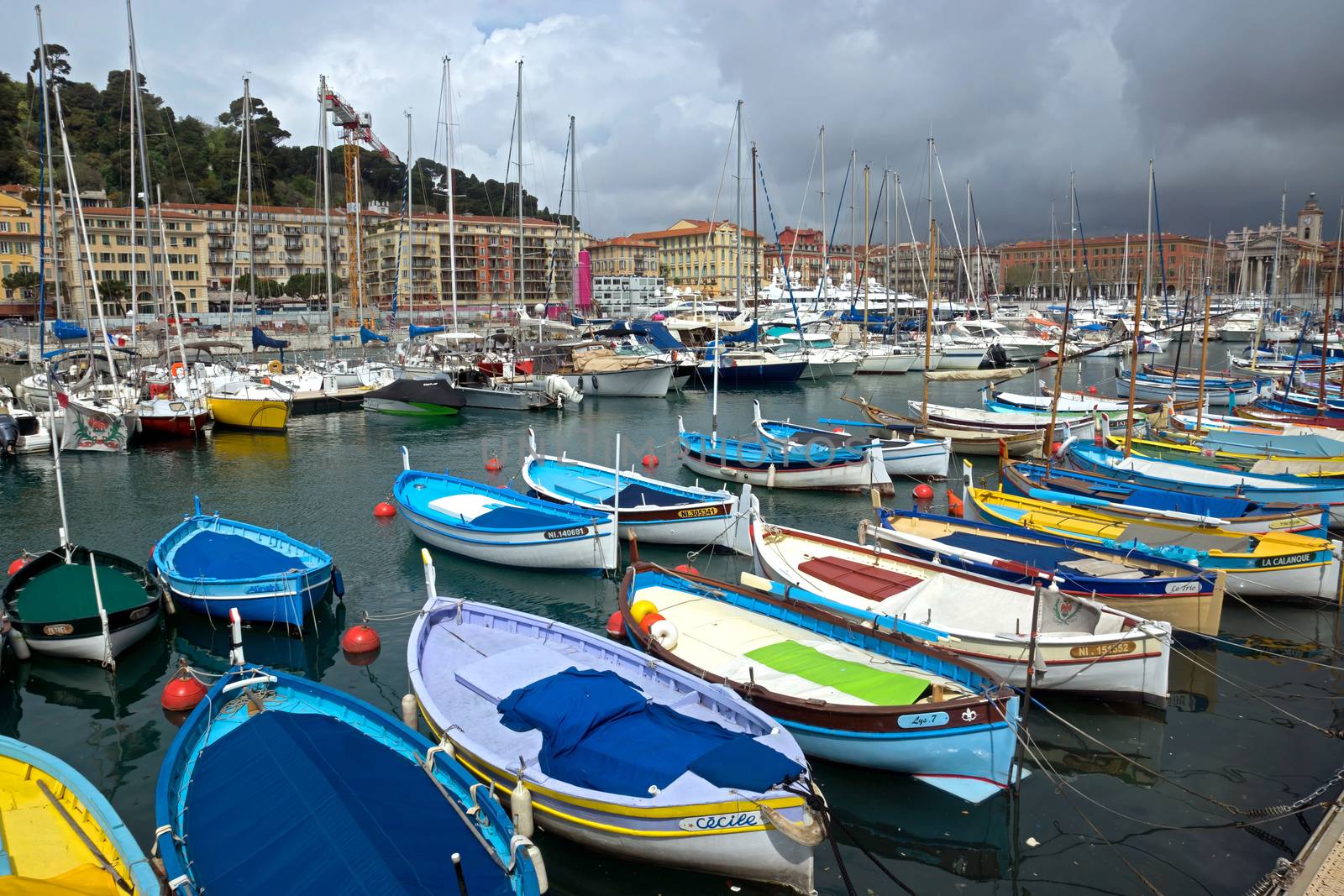 NICE, FRANCE - APRIL 27: Colorful buildings and boats within a Port de Nice on April 27, 2013 in Nice, France. Port de Nice was started in 1745.

Nice, France - April 27, 2013: Colorful buildings and boats within a Port de Nice in French Riviera. Port de Nice was started in 1745.