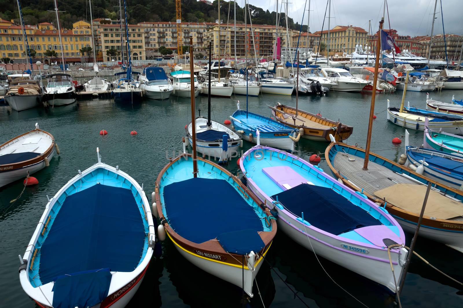 NICE, FRANCE - APRIL 27: Colorful buildings and boats within a Port de Nice on April 27, 2013 in Nice, France. Port de Nice was started in 1745.

Nice, France - April 27, 2013: Colorful buildings and boats within a Port de Nice in French Riviera. Port de Nice was started in 1745.