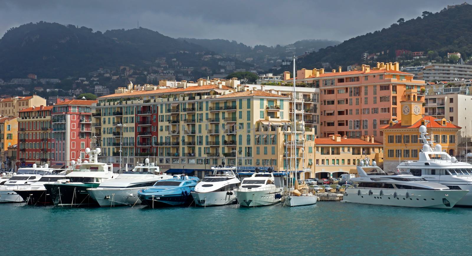 NICE, FRANCE - APRIL 27: Colorful buildings and boats within a Port de Nice on April 27, 2013 in Nice, France. Port de Nice was started in 1745.

Nice, France - April 27, 2013: Colorful buildings and boats within a Port de Nice in French Riviera. Port de Nice was started in 1745.