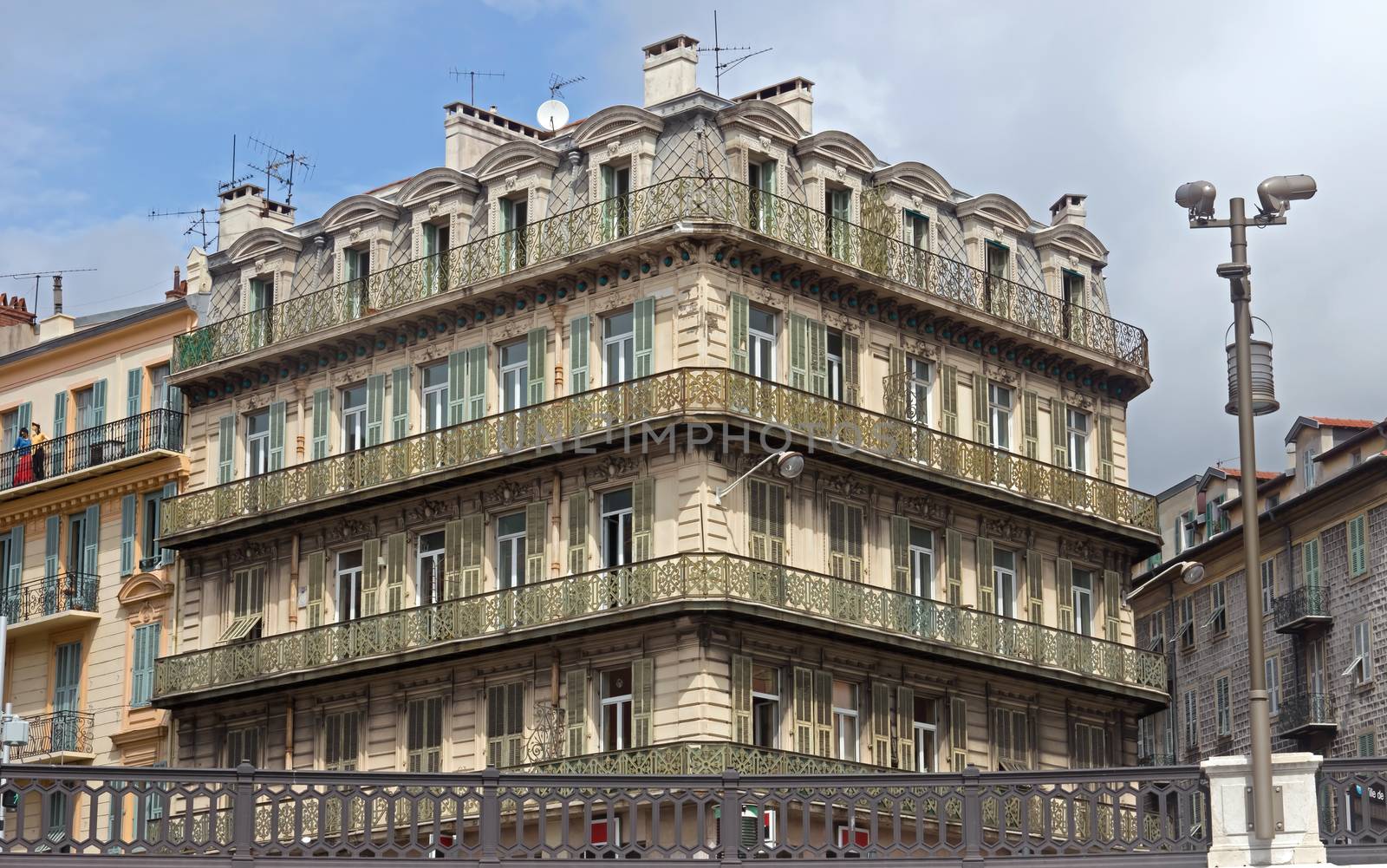 NICE, FRANCE - APRIL 27: Architecture along Promenade des Anglais on April 27, 2013 in Nice, France. It is a symbol of the Cote d'Azur and was built in 1830 at the expense of the British colony.

Nice, France - April 27, 2013: Architecture along Promenade des Anglais. People are walking. Promenade des Anglais is a symbol of the Cote d'Azur and was built in 1830 at the expense of the British colony.