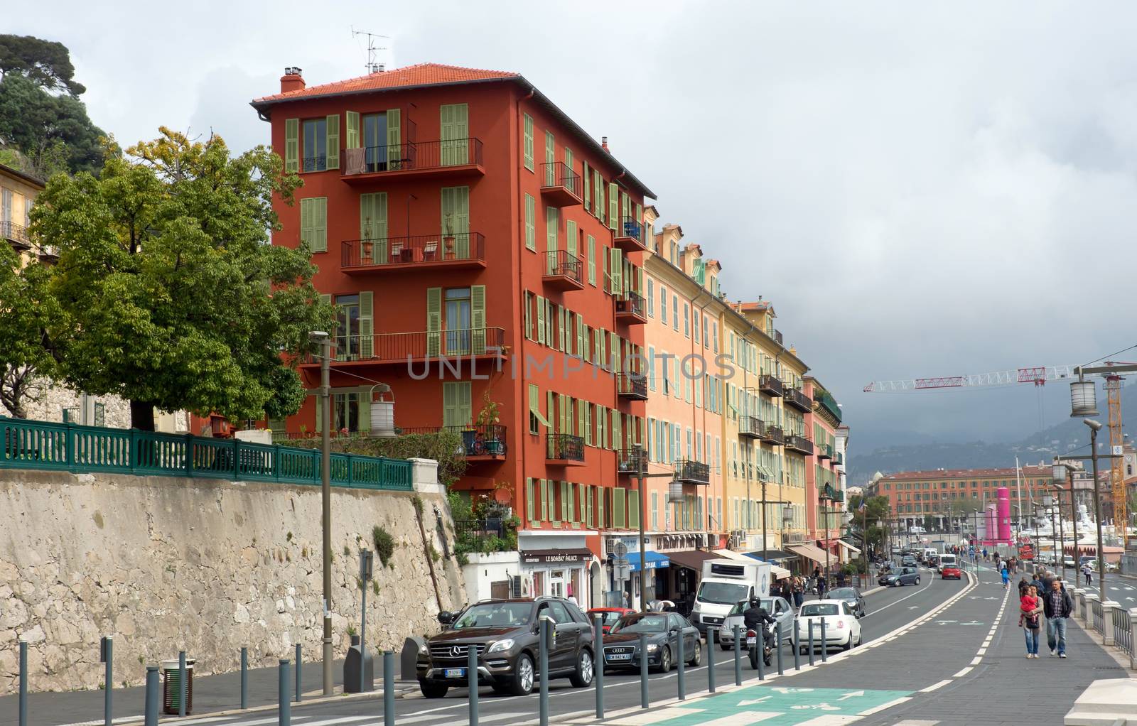 NICE, FRANCE - APRIL 27: Architecture along Promenade des Anglais on April 27, 2013 in Nice, France. It is a symbol of the Cote d'Azur and was built in 1830 at the expense of the British colony.

Nice, France - April 27, 2013: Architecture along Promenade des Anglais. People are walking. Promenade des Anglais is a symbol of the Cote d'Azur and was built in 1830 at the expense of the British colony.

