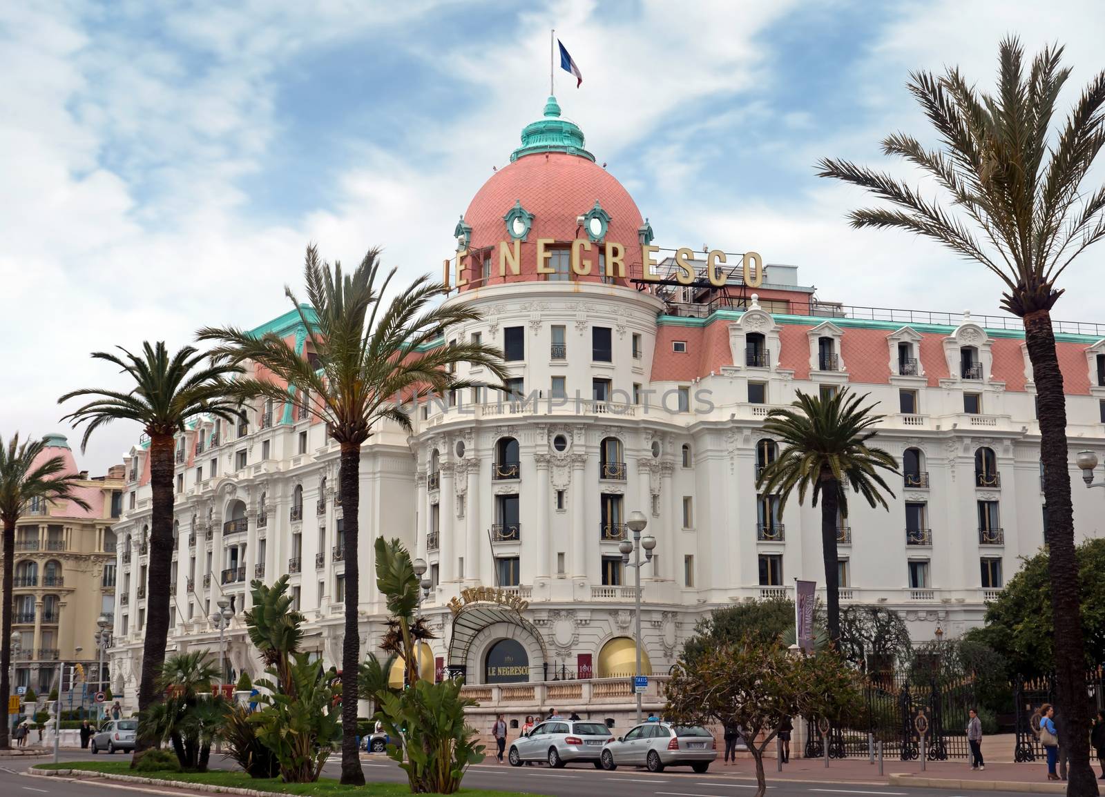 NICE, FRANCE - APRIL 27: Luxury Hotel Negresco on April 27, 2013 in Nice, France. Hotel Negresco is the famous luxury hotel on the Promenade des Anglais in Nice, a symbol of the Cote d'Azur.

Nice, France - April 27, 2013: Luxury Hotel Negresco on English Promenade in Nice, French Riviera. Hotel Negresco is the famous luxury hotel on the Promenade des Anglais in Nice, a symbol of the Cote d'Azur. People are walking.