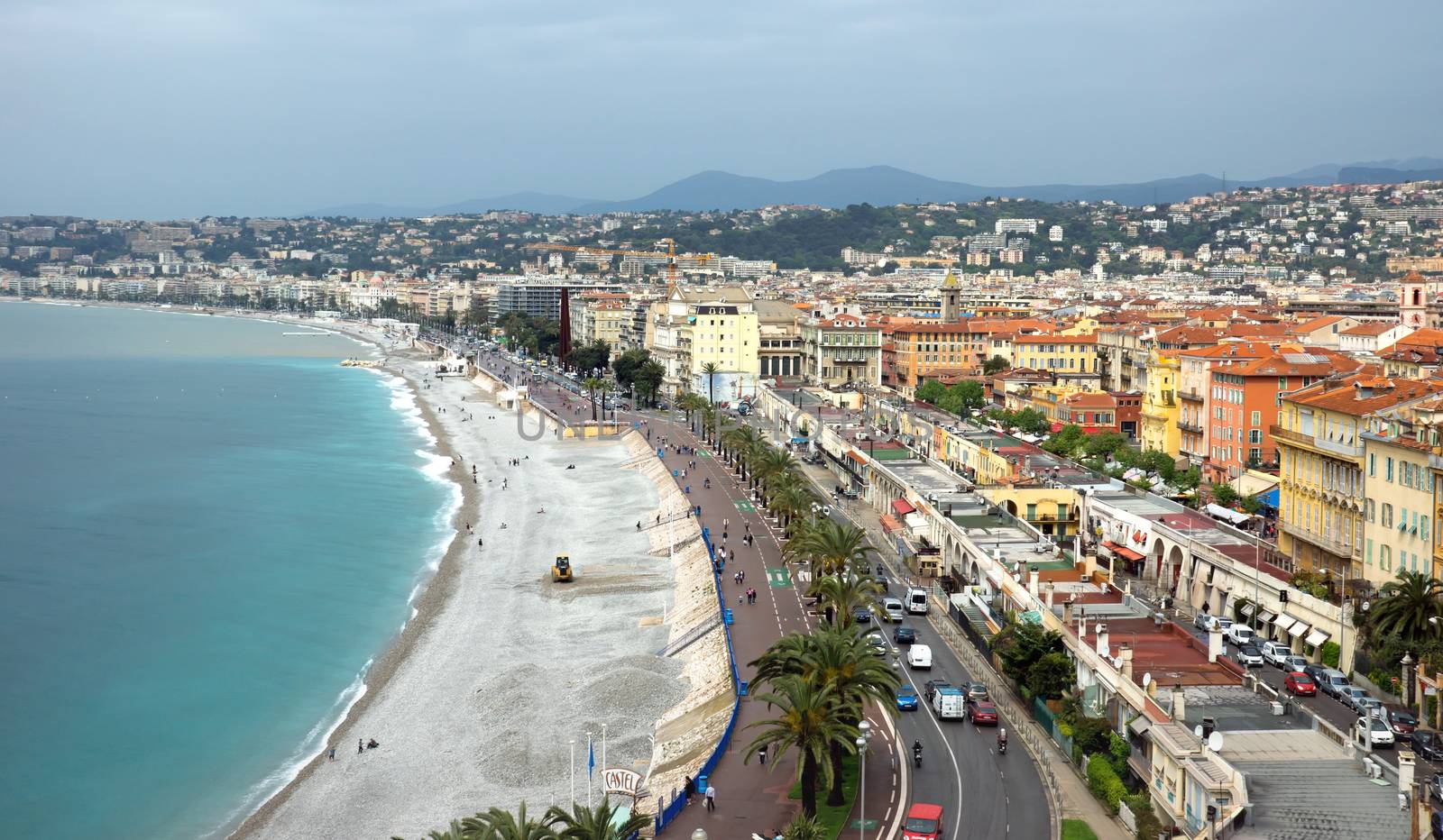 NICE, FRANCE - APRIL 29: Architecture along Promenade des Anglais on April 29, 2013 in Nice, France. It is a symbol of the Cote d'Azur and was built in 1830 at the expense of the British colony.

Nice, France - April 29, 2013: Architecture along Promenade des Anglais. People are resting. Promenade des Anglais is a symbol of the Cote d'Azur and was built in 1830 at the expense of the British colony.