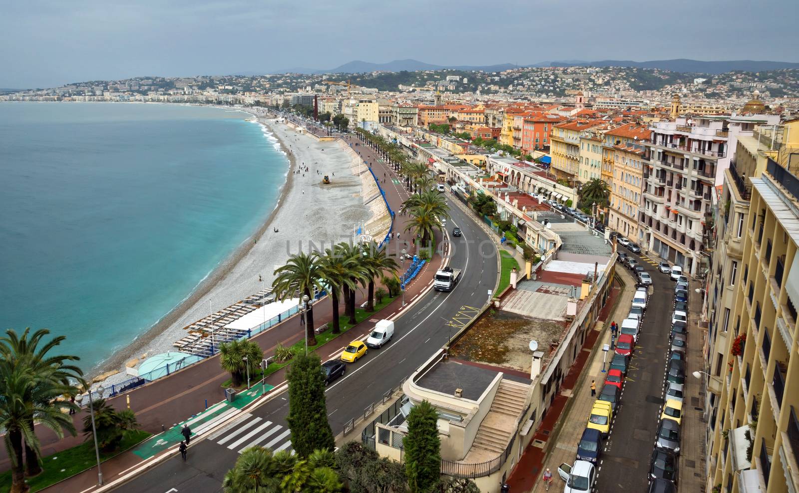 NICE, FRANCE - APRIL 29: Architecture along Promenade des Anglais on April 29, 2013 in Nice, France. It is a symbol of the Cote d'Azur and was built in 1830 at the expense of the British colony.

Nice, France - April 29, 2013: Architecture along Promenade des Anglais. Promenade des Anglais is a symbol of the Cote d'Azur and was built in 1830 at the expense of the British colony. People are walking by street.